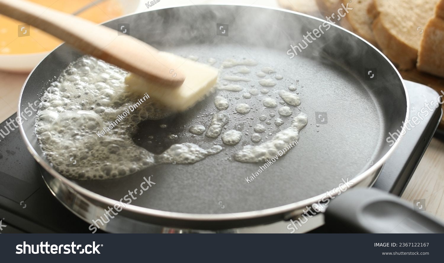 Butter in a hot frying pan. Bubbles and steam of melted butter. Cooking food. A series of photos of Bread with Egg Recipe. #2367122167