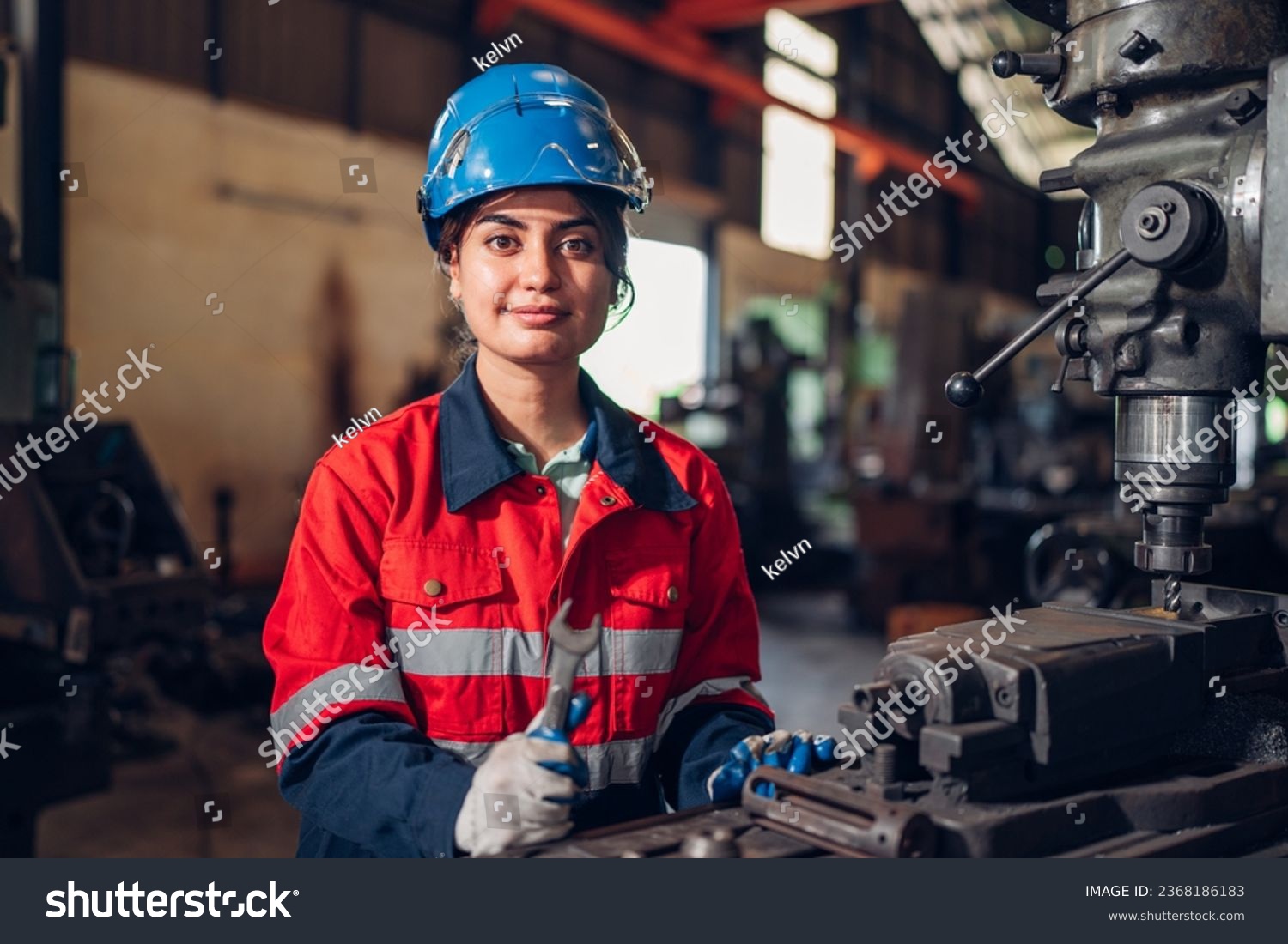 Portrait of female automation engineer standing in modern industrial factory and looking camera in industrial factory. #2368186183