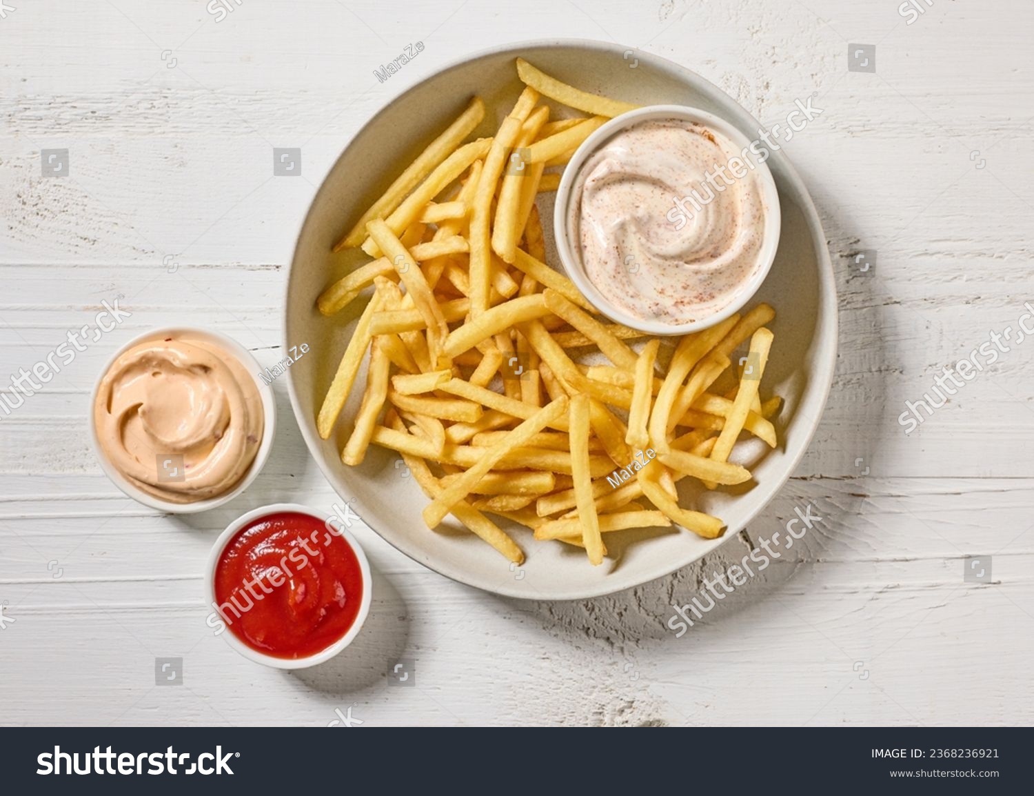 french fries with various dip sauces on white wooden table, top view #2368236921