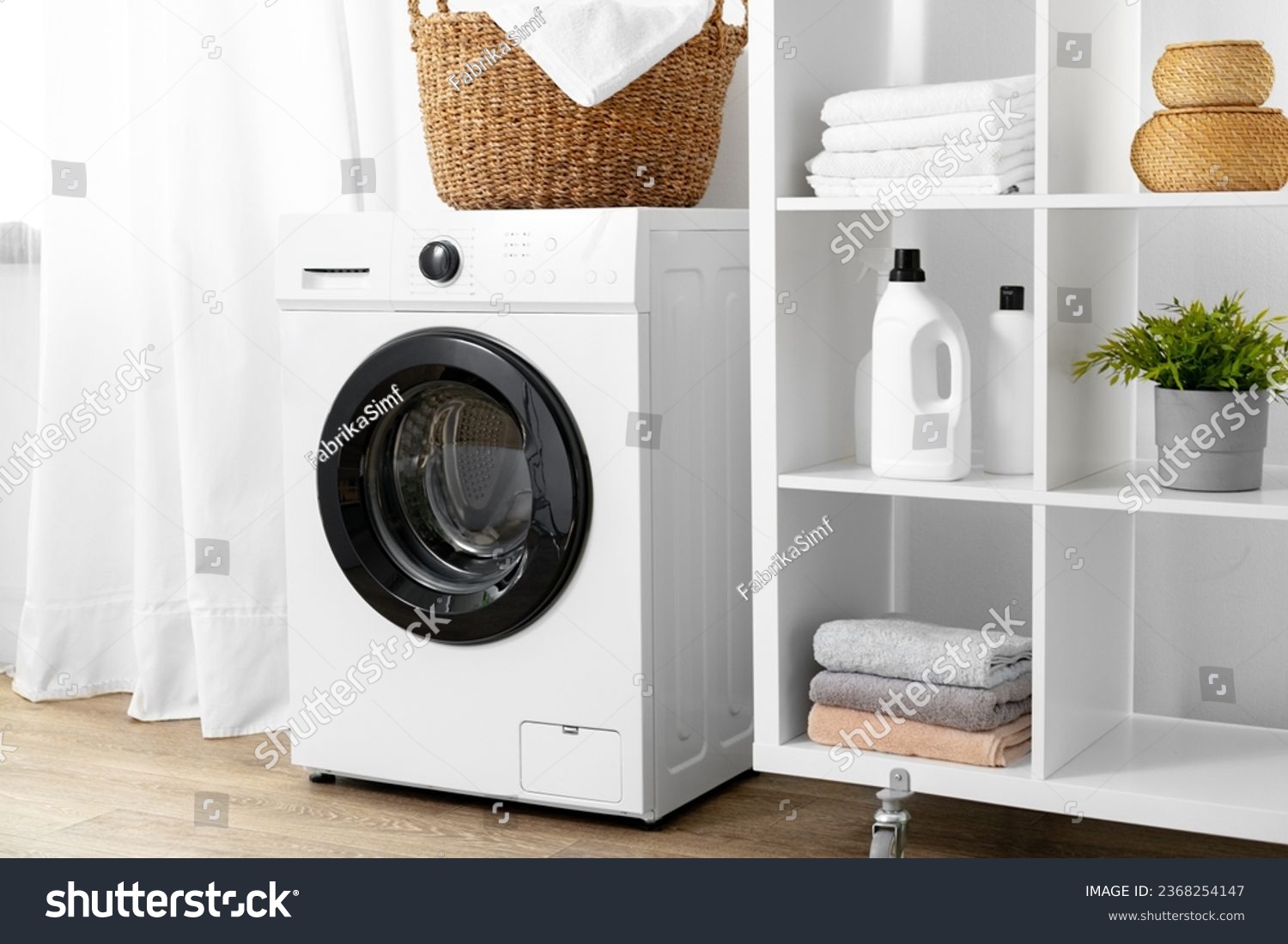 Modern white washing machine in a laundry room #2368254147