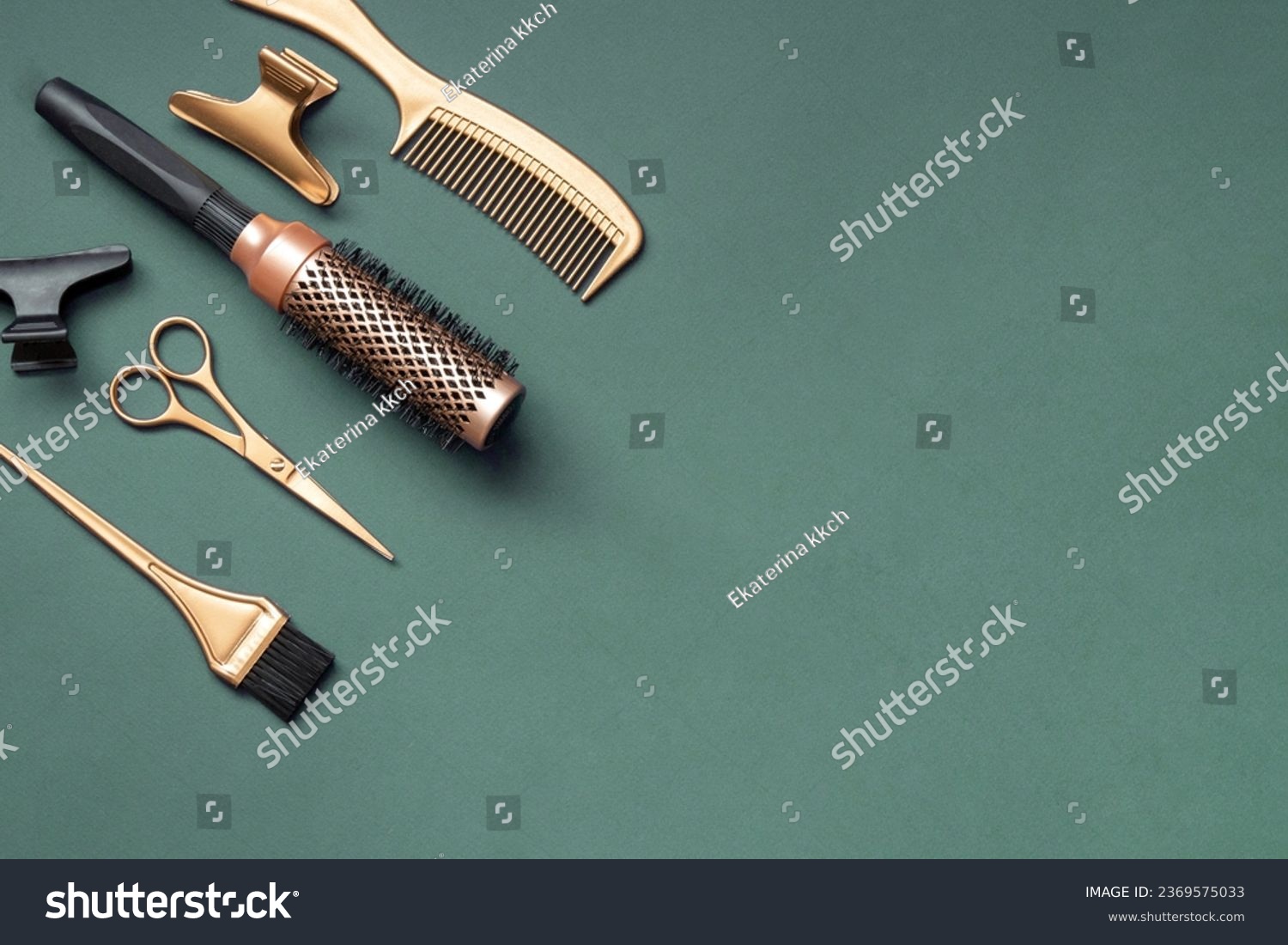 Golden hairdressing tools scissors combs on green background. Horizontal template with hair salon accessories and copy space. #2369575033