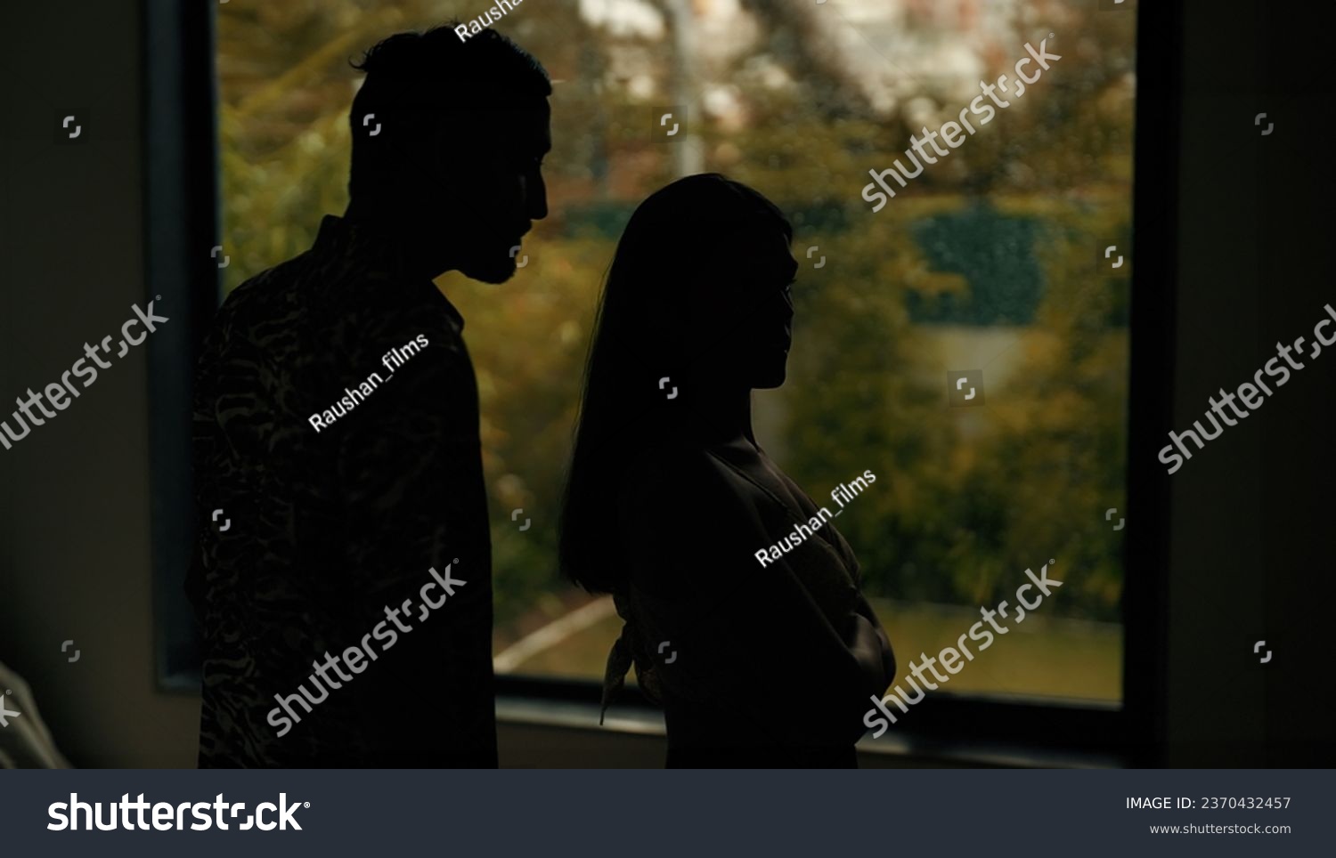 Indian stressed upset tense husband wife arguing fighting shouting on each other at dark indoor home. Silhouette angry sad boyfriend girlfriend quarreling screaming on family problems in evening house #2370432457