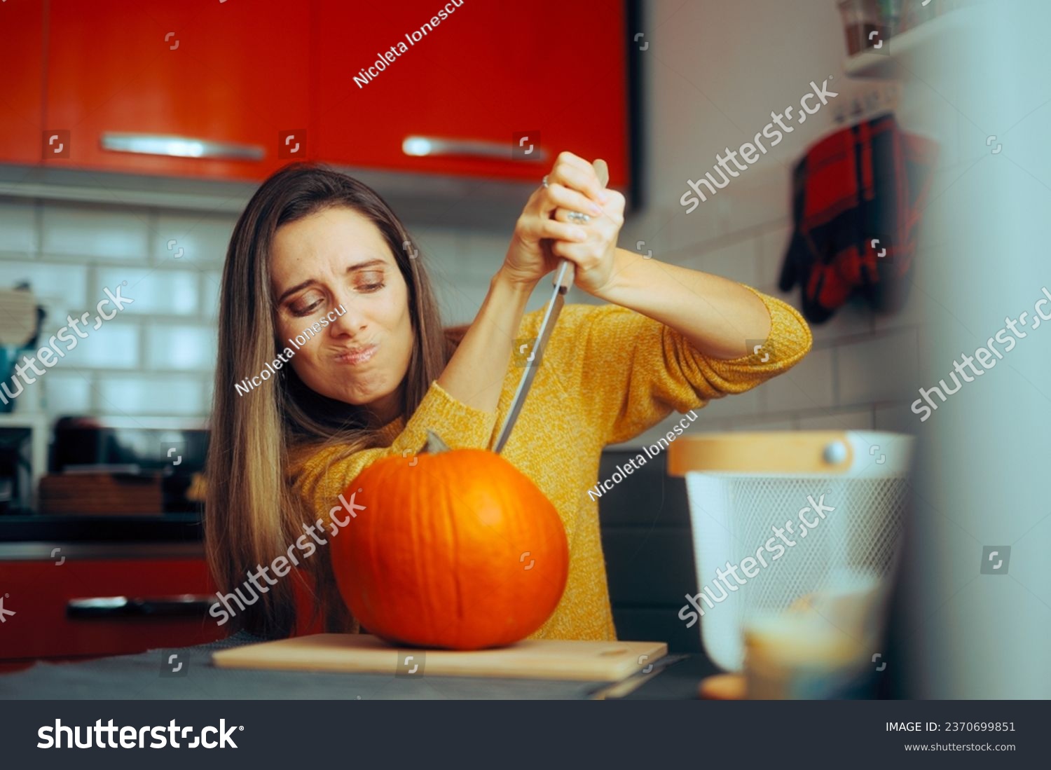 
Woman Holding a Knife Ready to Carve a Halloween Pumpkin. Stressed lady feeling bored thinking what to cook for autumnal holidays
 #2370699851