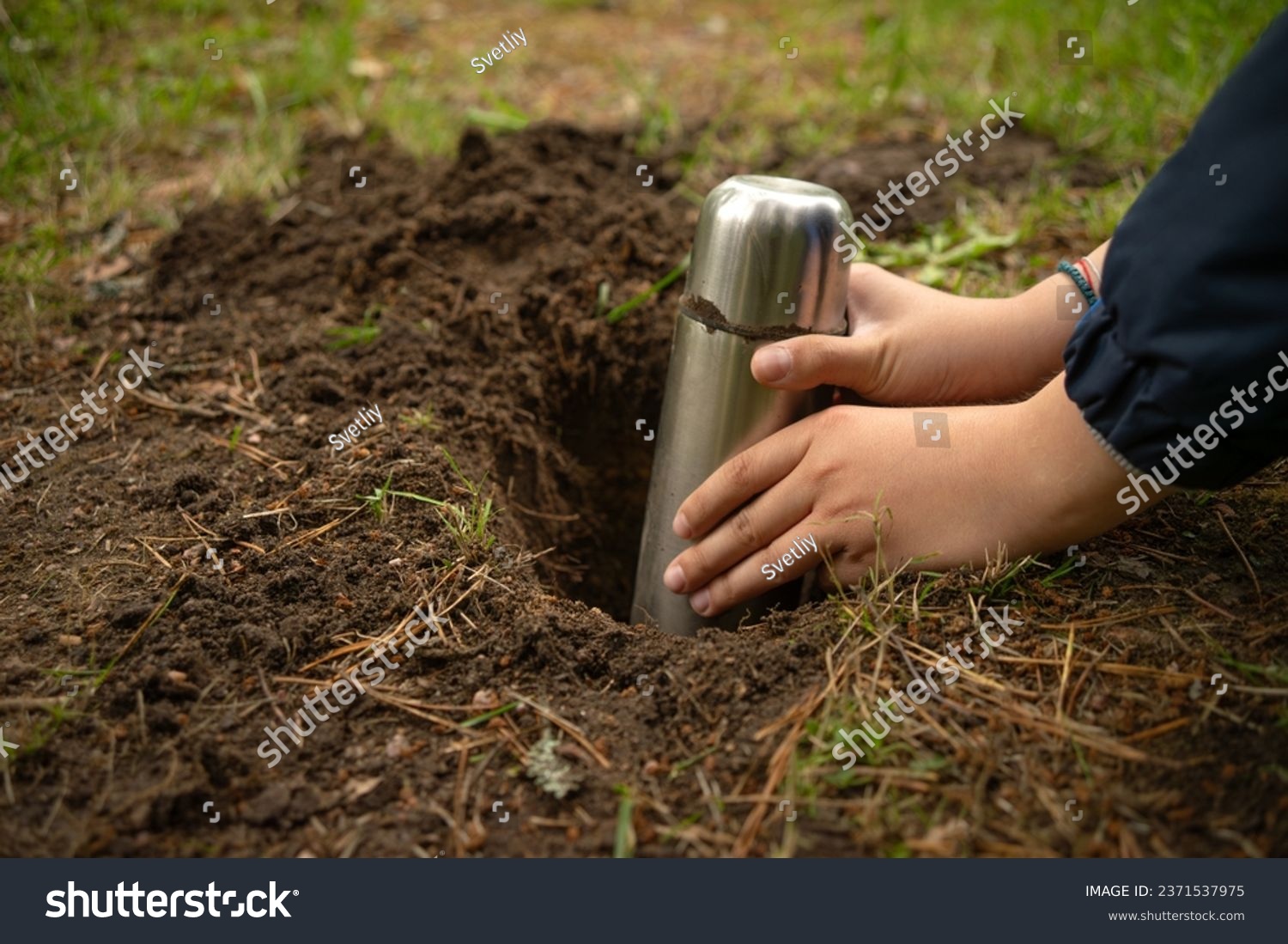 Bury a time capsule in the ground.Leave a message for the future in the ground.Hide a treasure with a child in the forest. #2371537975
