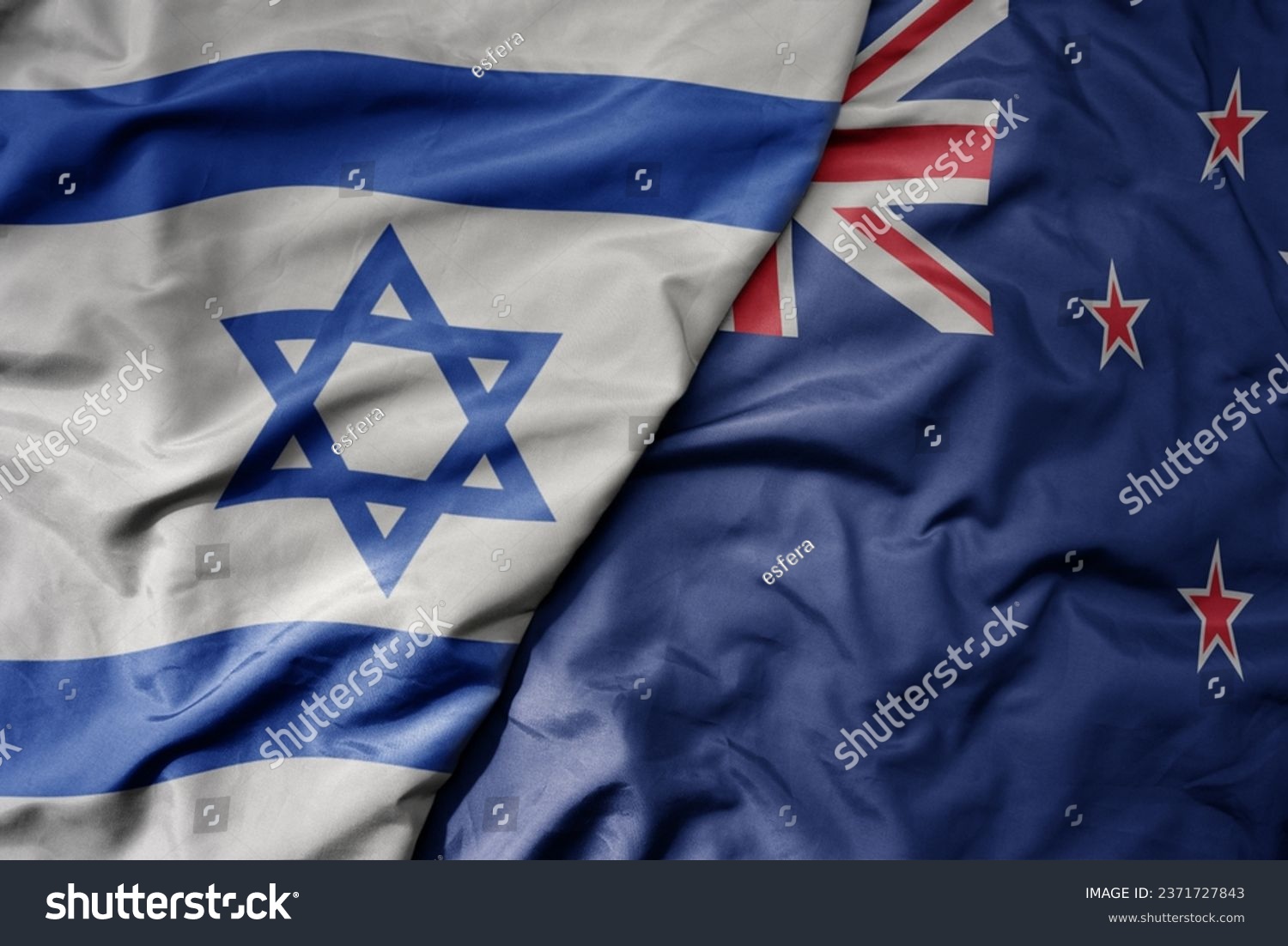 big waving national colorful flag of israel and national flag of new zealand . macro #2371727843
