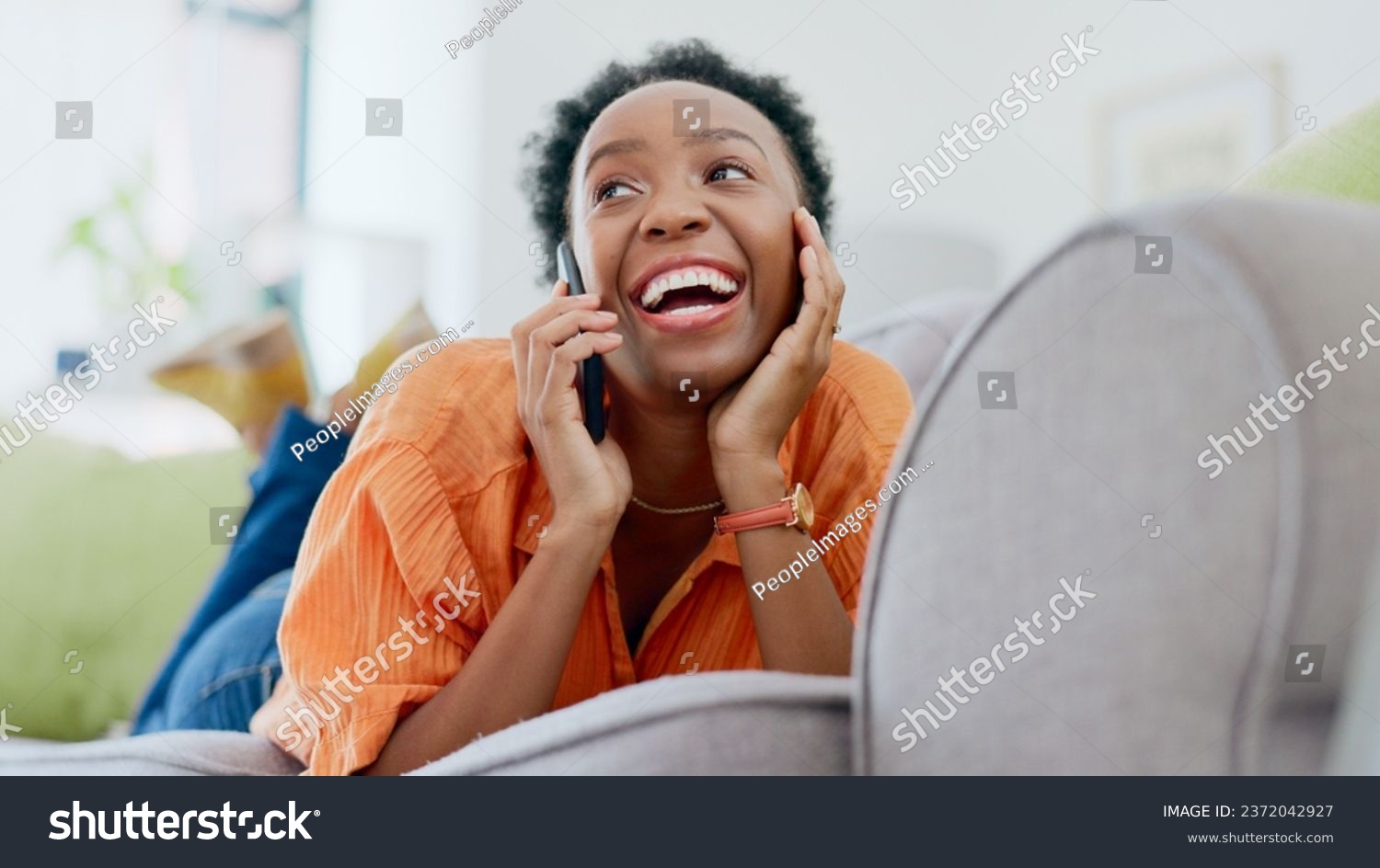 Relax, phone call or happy black woman on couch in communication in house living room. Smile, mobile contact or excited African lady talking or speaking of gossip in discussion or connection on sofa #2372042927