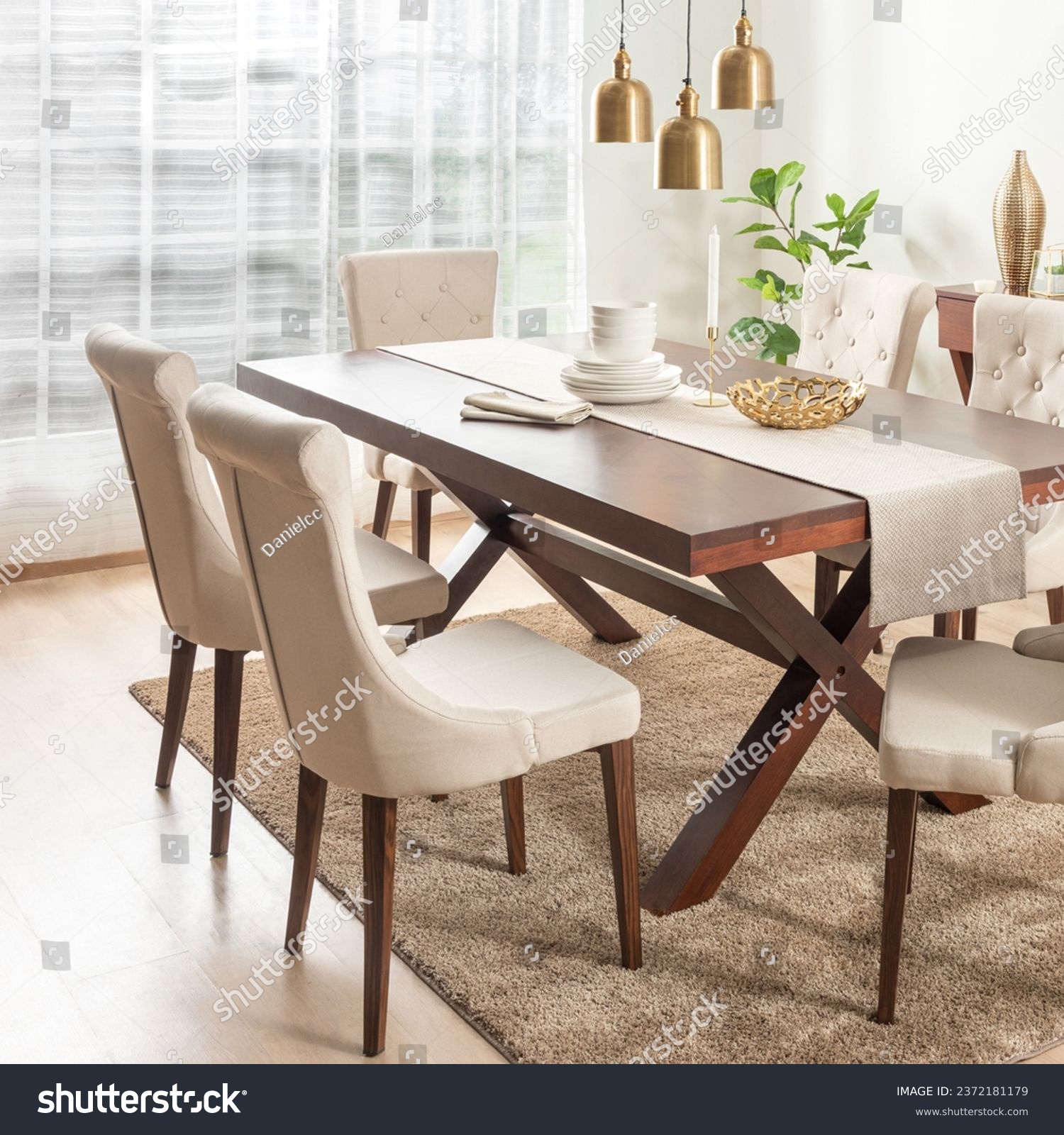 Dining Room with Rectangle Wooden Dining Table Set and Fabric Beige Button Dining Chairs with Wooden Legs, Adorned by Linen Table Runner, White Ceramic Dinnerware Set, and Ornaments on the Table. #2372181179