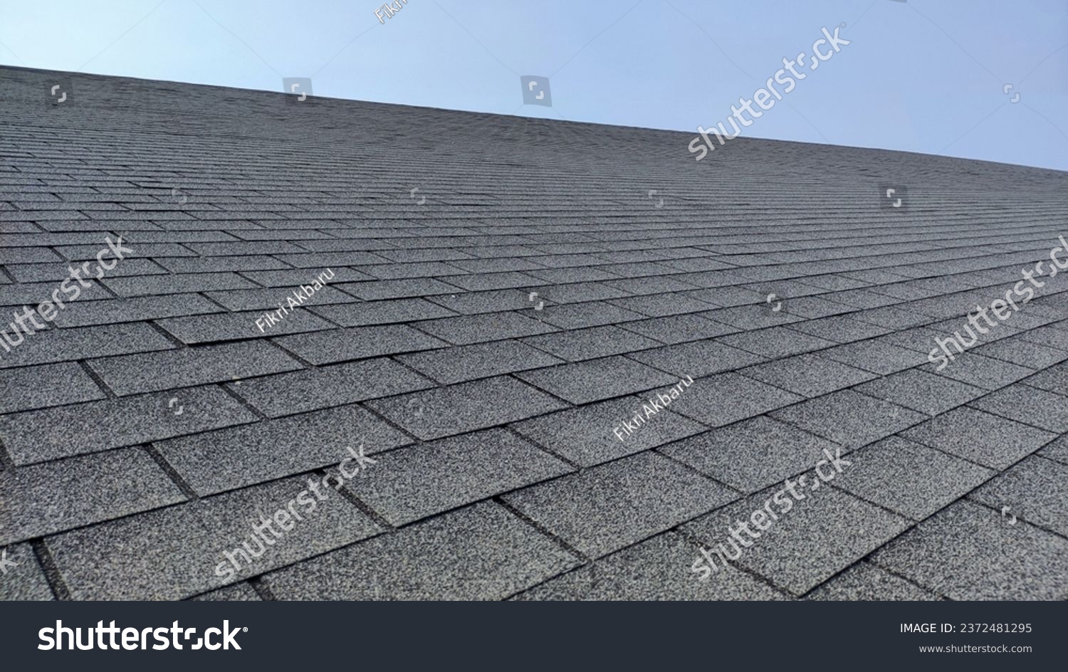 light steel shingle roof house, covered with rocks under the blue sky #2372481295