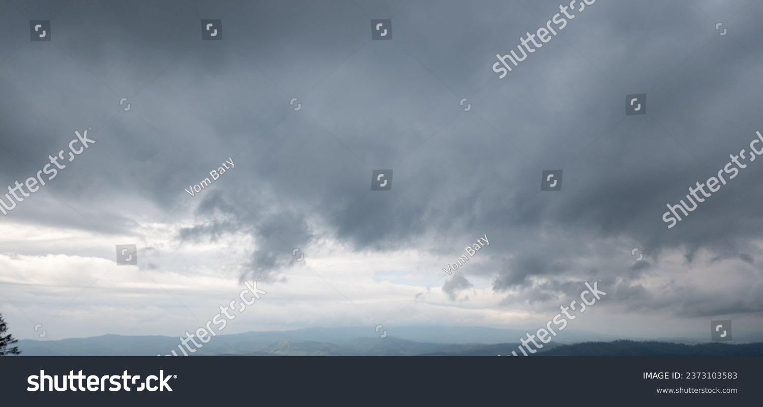 Autumn brings overcast skies adorned with gray stratus clouds, hinting at impending rain. This full-screen view provides ample space for text or design elements, making it perfect for various projects #2373103583