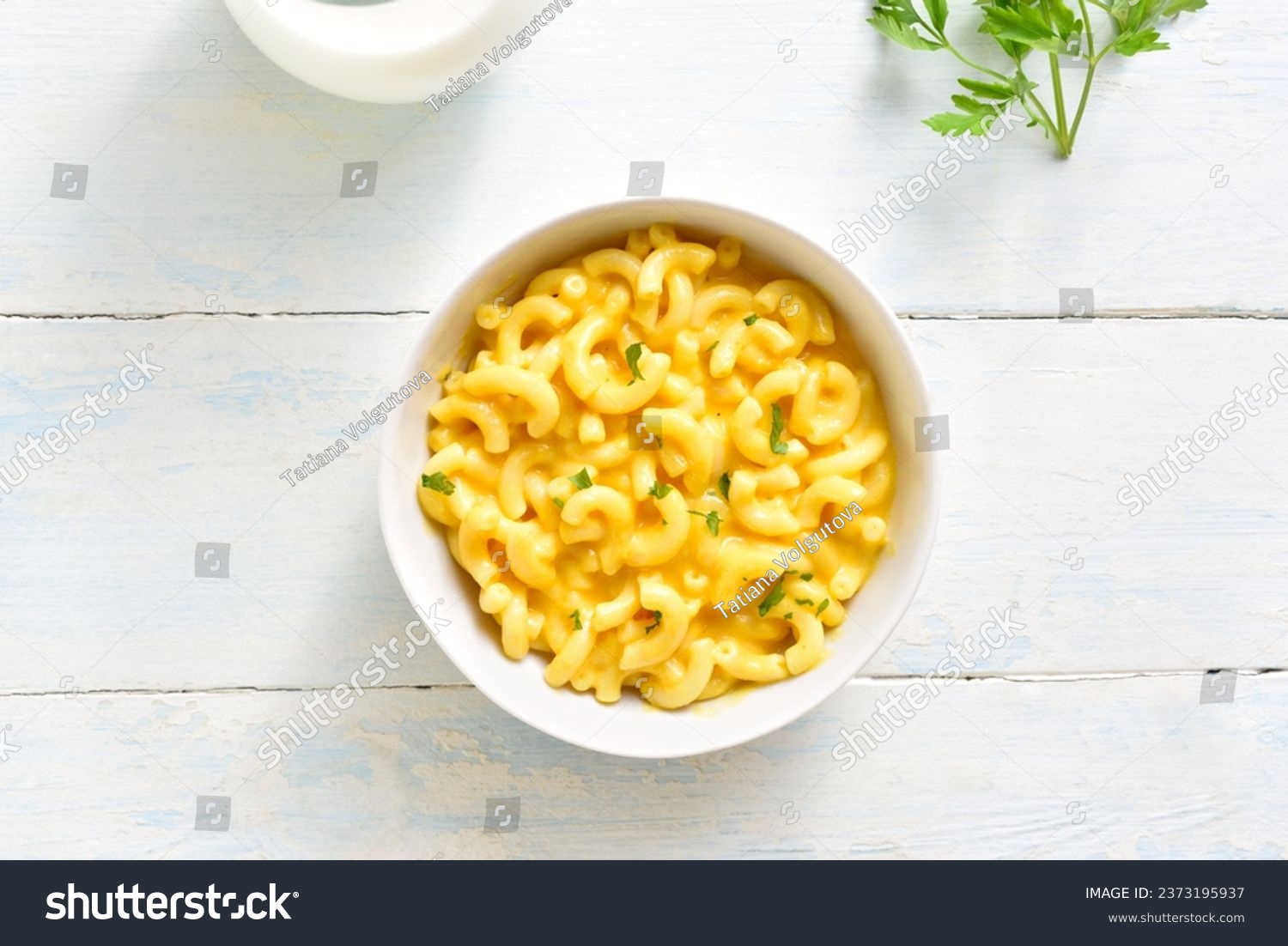 Macaroni and cheese in bowl over wooden background. Top view, flat lay #2373195937