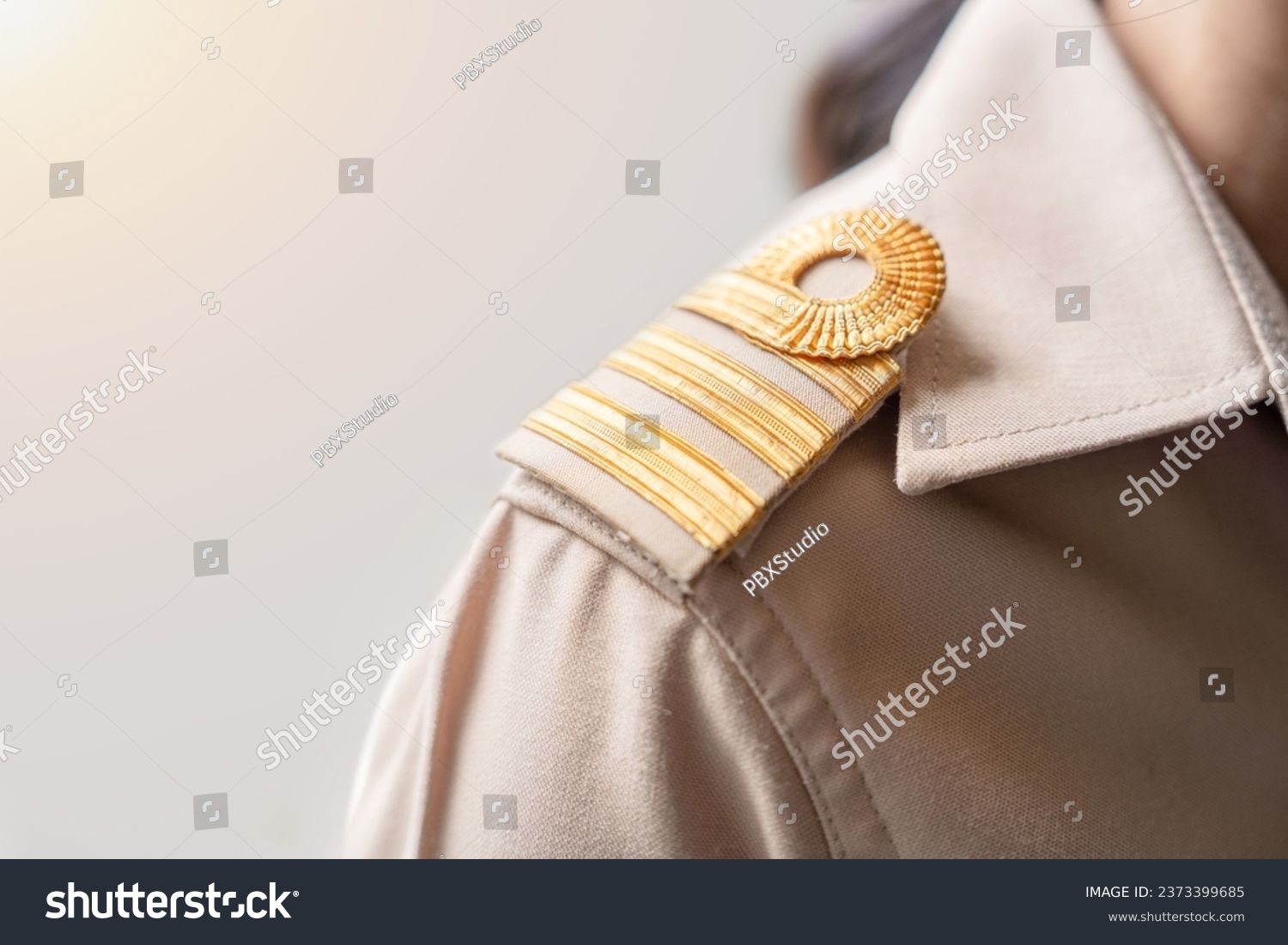 Photo of a brown uniform with a gold stripe on the shoulder, Thai civil servant uniform. #2373399685