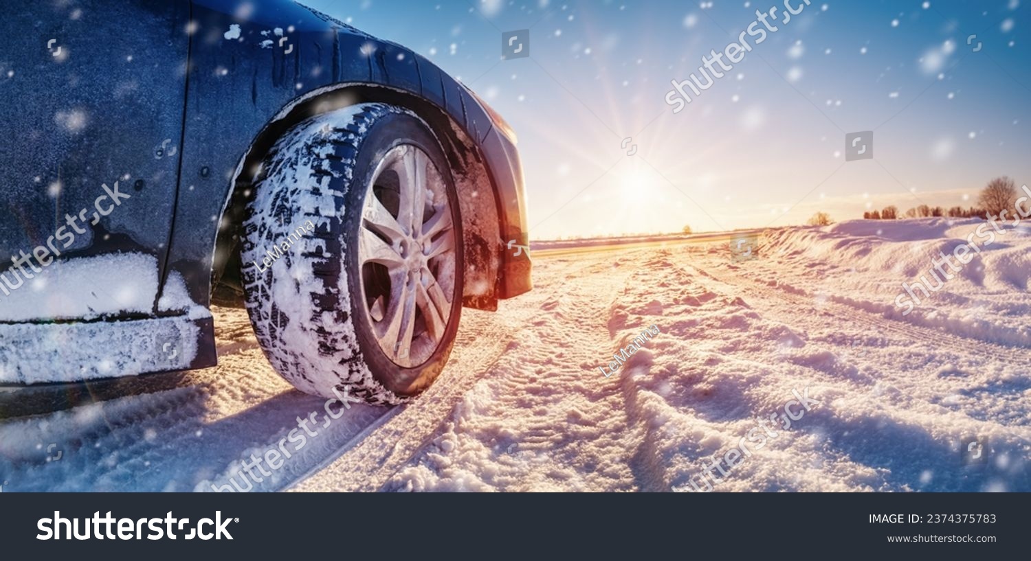 Closeup view of the car's wheel on the snowy road in natural park #2374375783