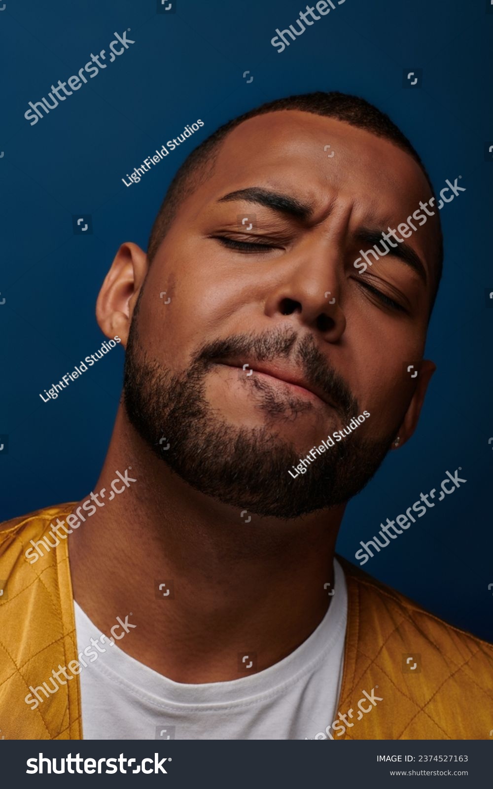 portrait of contented handsome african american man with beard closing his eyes, fashion concept #2374527163
