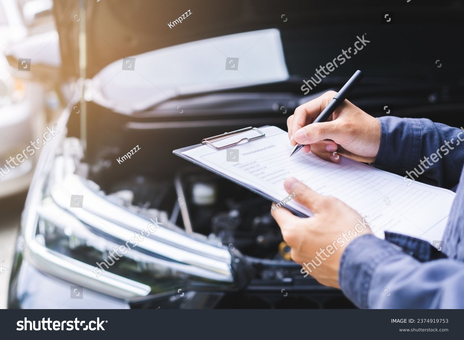 Auto check, car service shop concept. Automobile repairman writing job checklist on clipboard, mechanic checking engine to estimate repair machine, inspecting maintenance by engineer at vehicle garage #2374919753