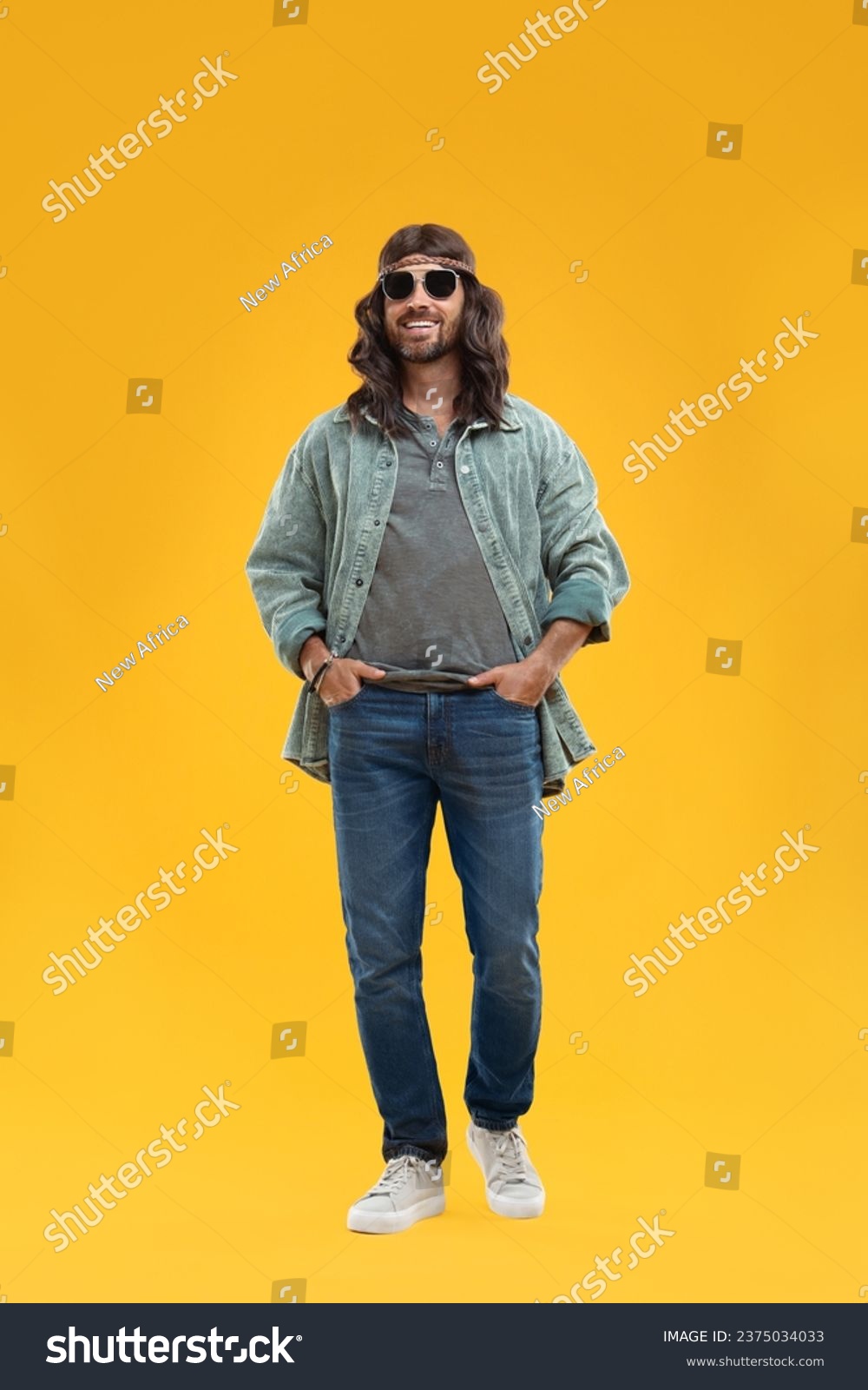 Stylish hippie man in sunglasses on orange background #2375034033