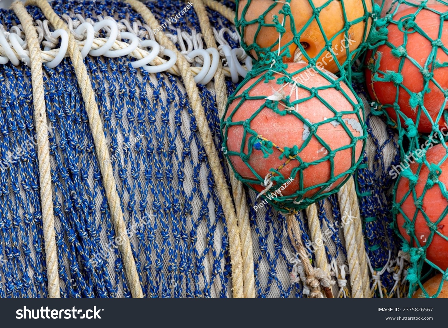 View of fishing nets rolled up on the large drum of a fishing boat. #2375826567