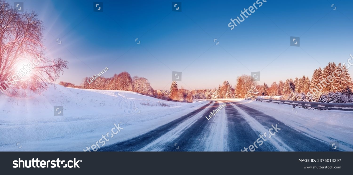 Beautiful winter road in natural sunny park. #2376013297