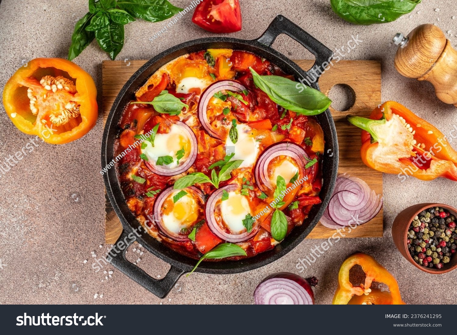 Shakshuka. Fried eggs with vegetables in a cast iron pan, traditional middle eastern traditional dish place for text, top view, #2376241295