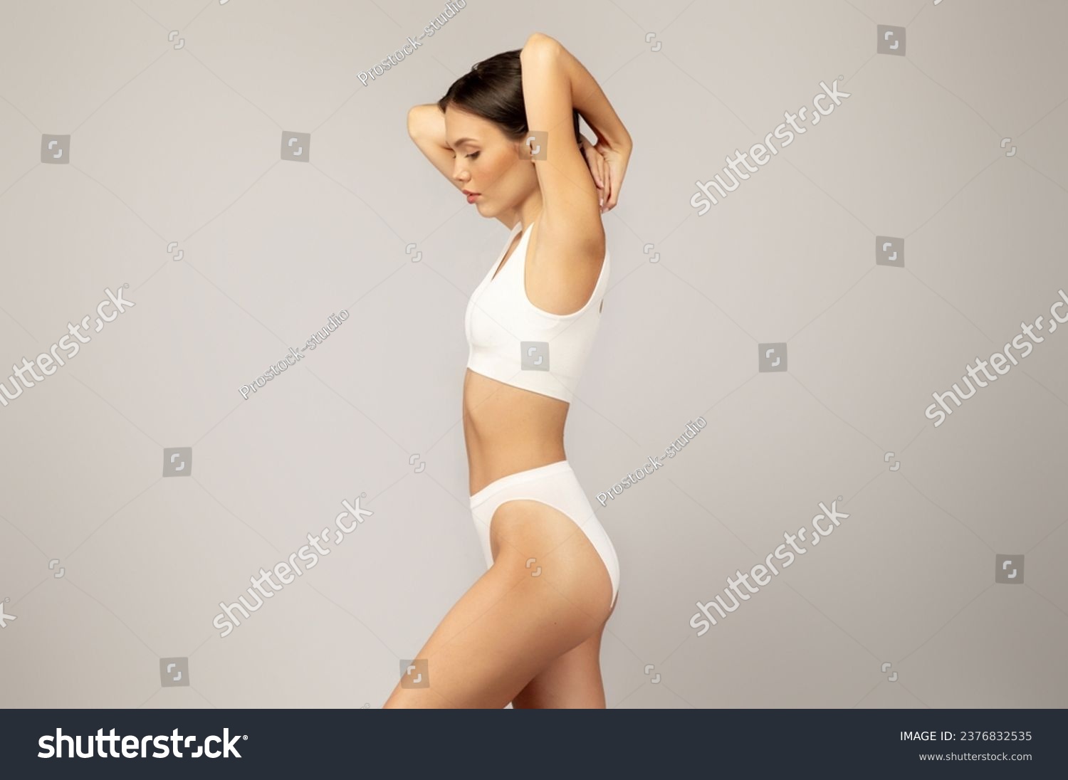 Calm serious asian slim young lady in underwear with perfect body, isolated on gray studio background. Natural beauty care, freshness and lifestyle, weight loss, procedures #2376832535