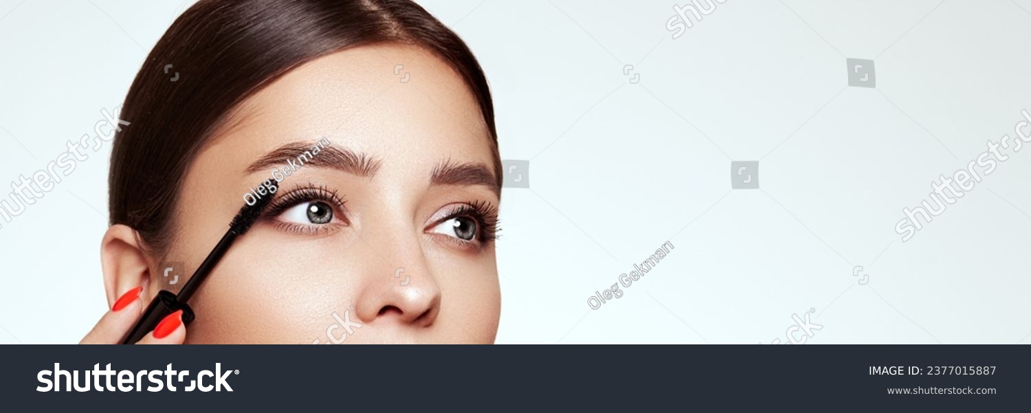 Beauty woman applying black mascara on eyelashes with makeup brush. Eyelash extensions. makeup, cosmetics. beauty, skincare #2377015887