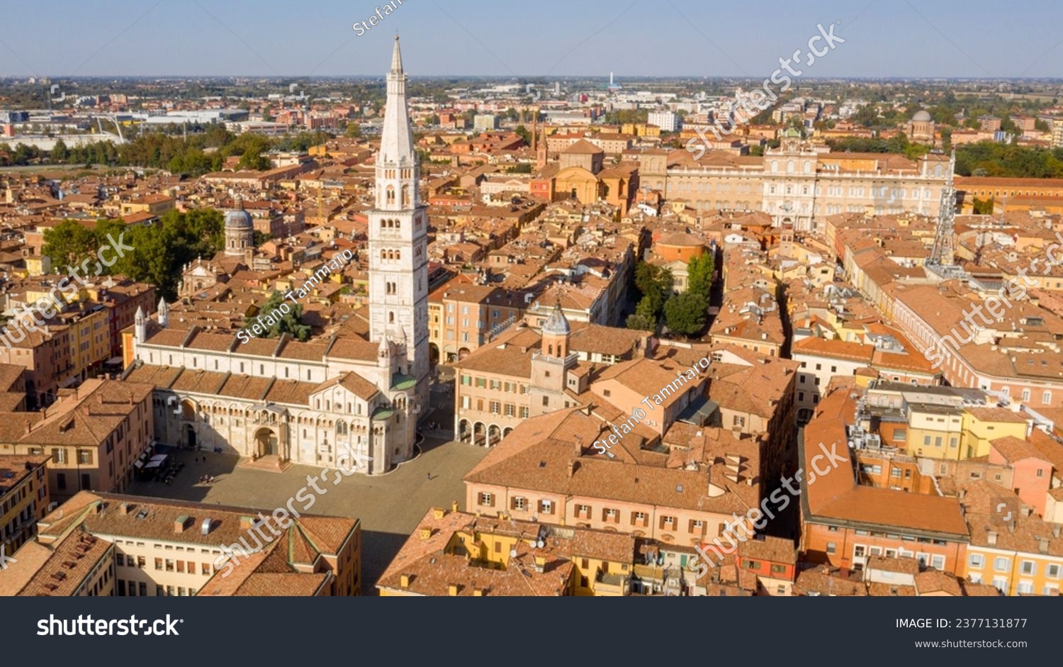 Aerial view of the Modena Cathedral and Torre della Ghirlandina, the bell tower of this Roman Catholic church. In background there is the Ducal Palace of Modena, Emilia Romagna, Italy. #2377131877