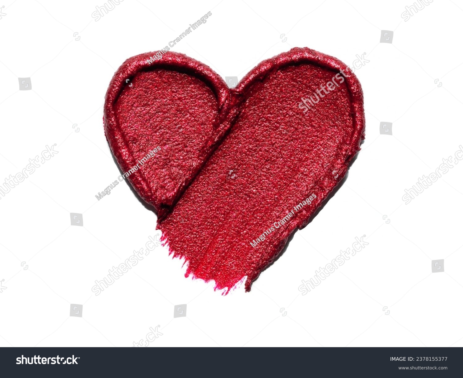 Red lipstick shimmering texture in heart shape, texture stroke isolated on white background. Cosmetic product smear smudge swatch #2378155377