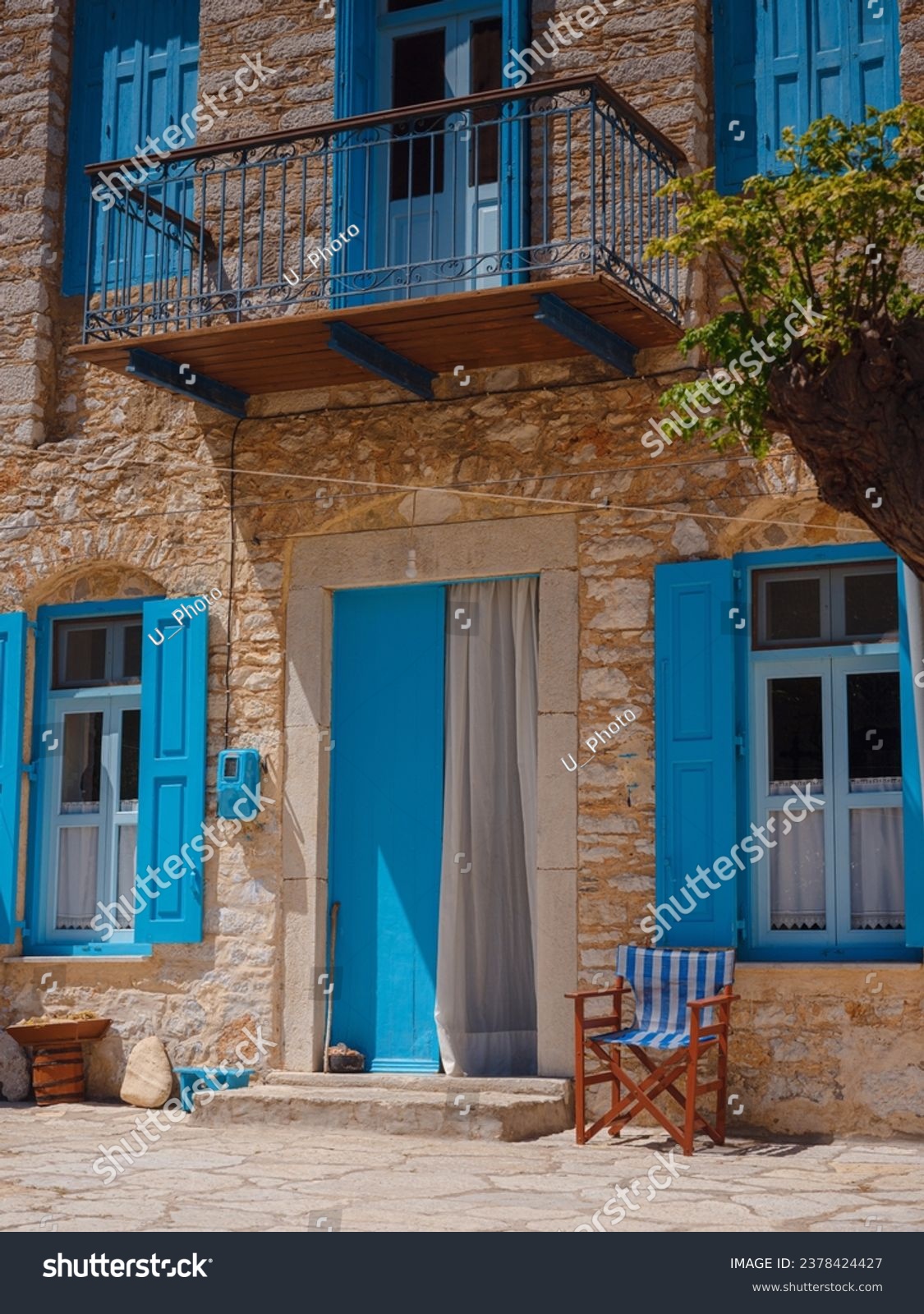 Cute details of windows, doors, balconies from old house in Simi island . Greece islands holidays from Rhodos in Aegean Sea. Colorful neoclassical houses in bay of Symi. Holiday travel background. #2378424427