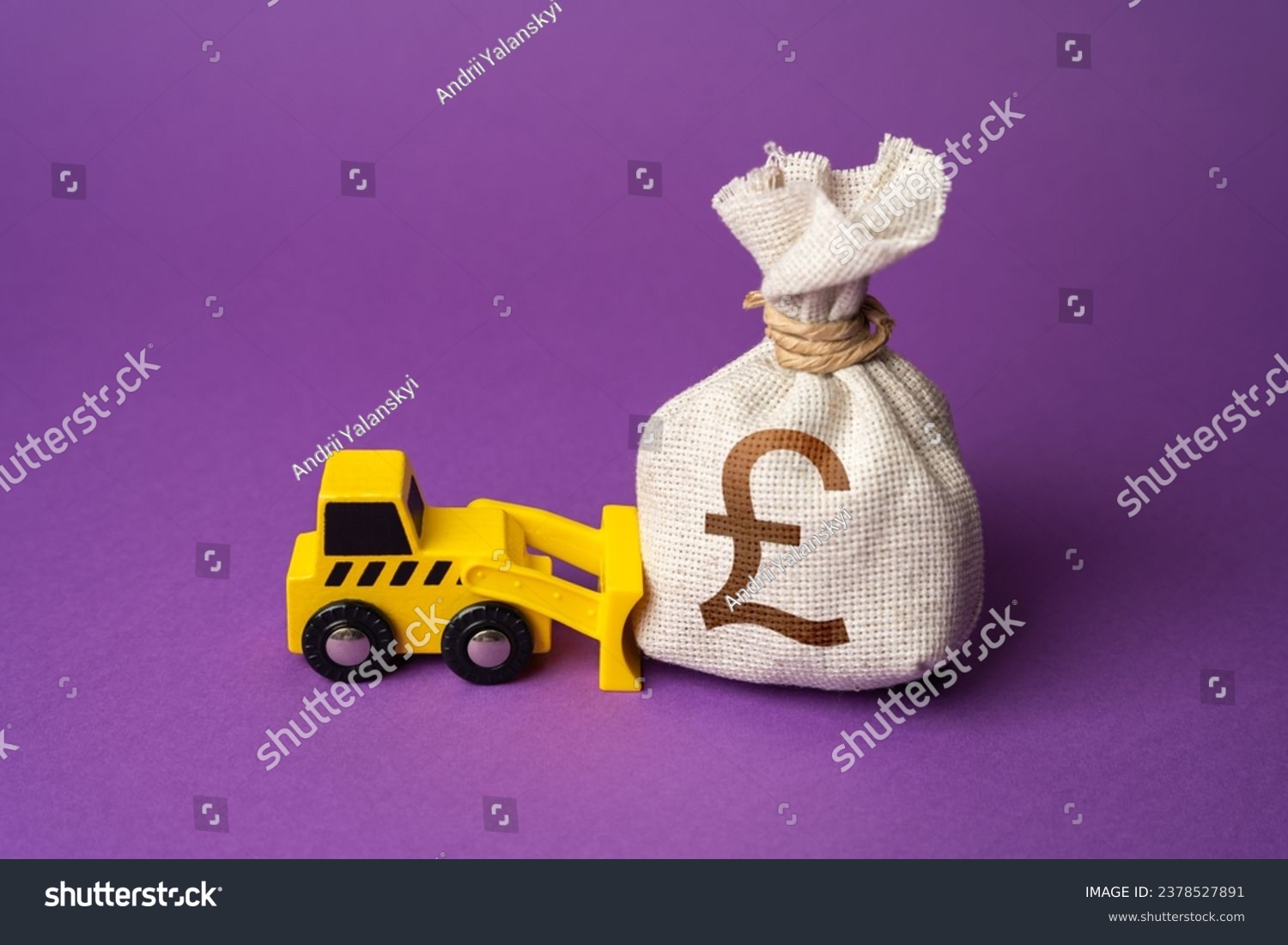A bulldozer pushes a british pound sterling moneфy bag. Ineffective use of funds. Money down the drain. Financing of dismantling works. Demolition services, land leveling. Industry machinery for rent. #2378527891
