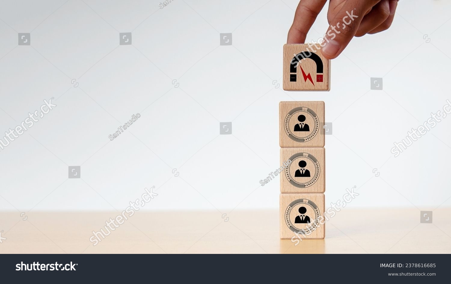 Businessman hold and put wooden cube block shape, Inbound marketing strategy, Wooden cubes with magnet icon attracts the customer icons.customer retention, digital marketing and attracting potential. #2378616685