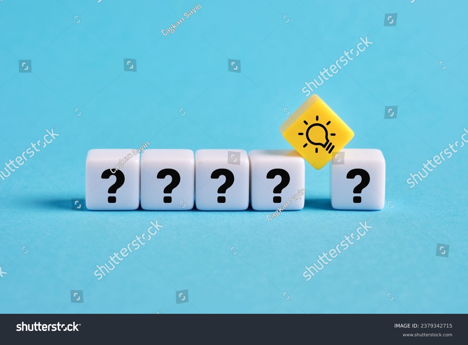 Problem solving. To find a creative business solution. Brainstorming and idea formation. Question mark and light bulb symbols on cubes. #2379342715