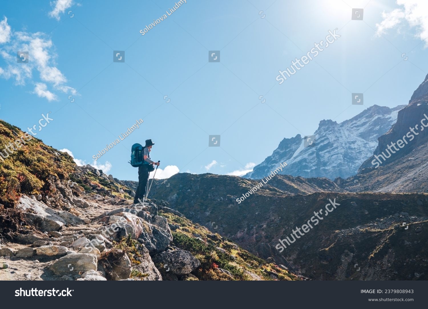 Young hiker backpacker man enjoying valley view in Makalu Barun Park route near Khare during high altitude acclimatization walk. Mera peak trekking route, Nepal. Active vacation concept image #2379808943