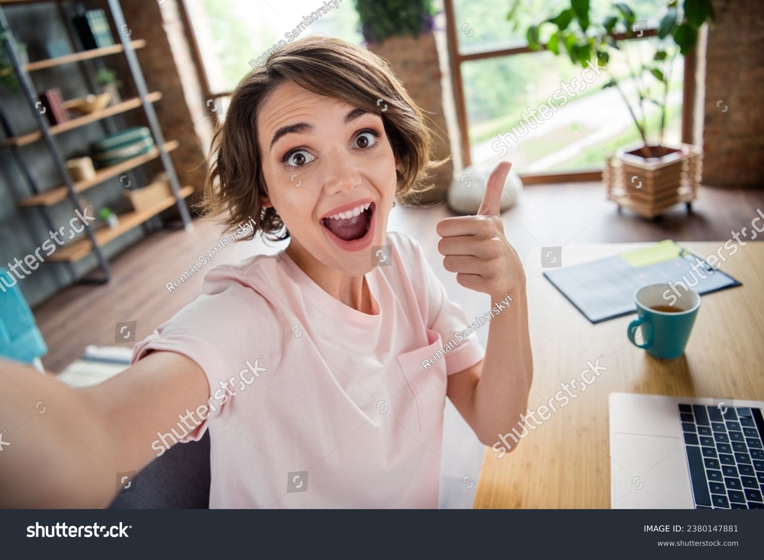 Selfie of young crazy impressed woman thumb up like feedback rate coffee break time for relax while work interior isolated house background #2380147881