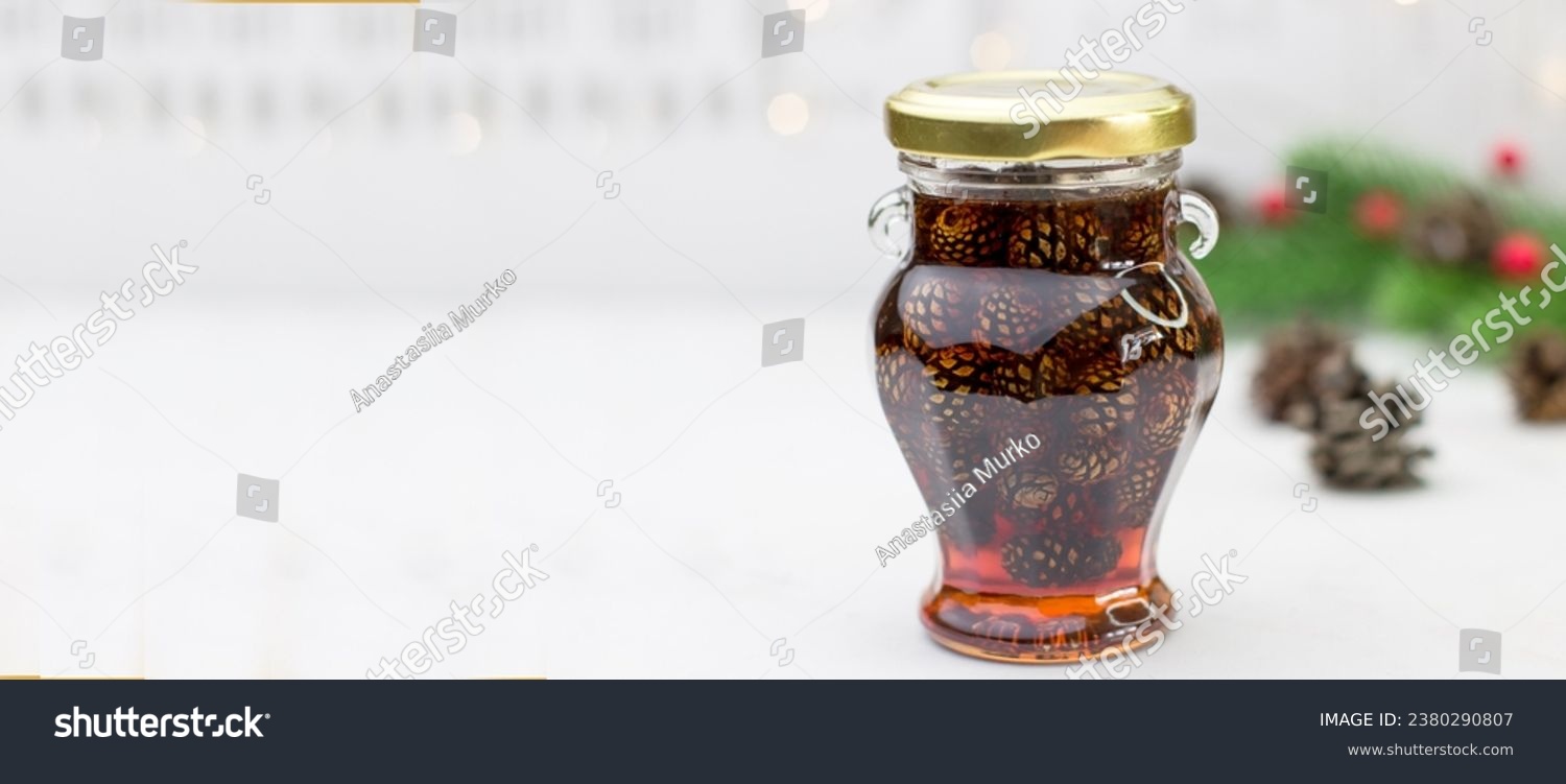 Banner with young pine cones jam in glass bowl. Delicious jam with the little pine cones. #2380290807