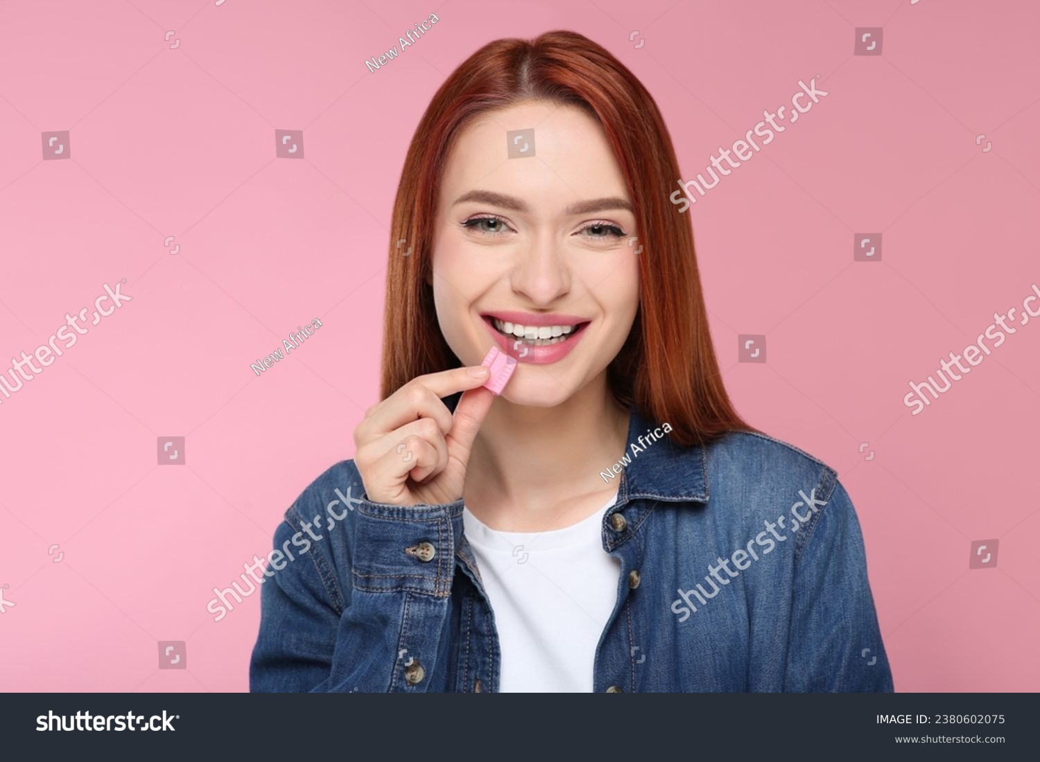Beautiful woman with bubble gum on pink background #2380602075