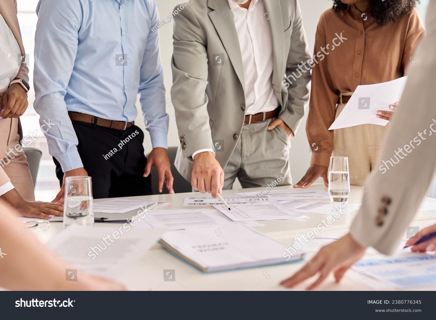 Executive business team people group working with paperwork standing at table, analyzing corporate strategy concept, reviewing plan, managing financial project overview at office meeting, close up. #2380776345