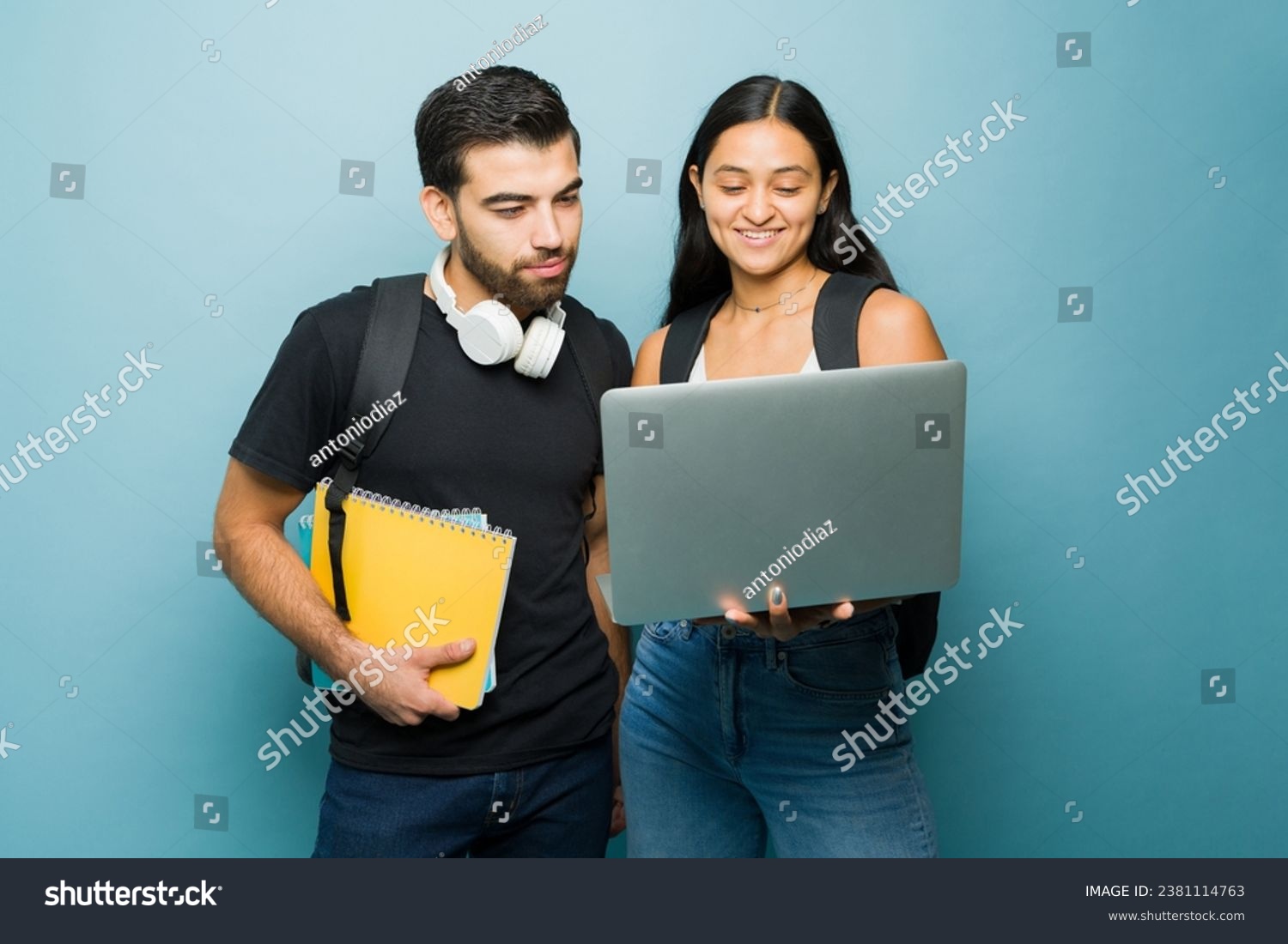 Smart university students and couple using the laptop and doing homework together while going to college  #2381114763