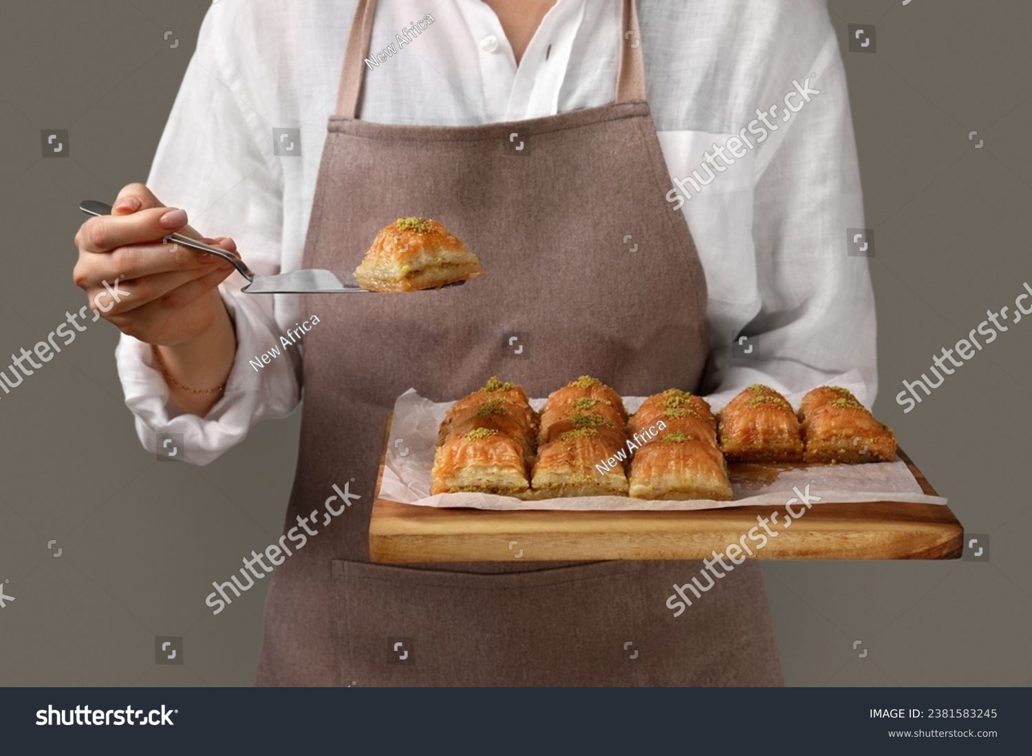 Woman with delicious sweet baklava on grey background, closeup #2381583245