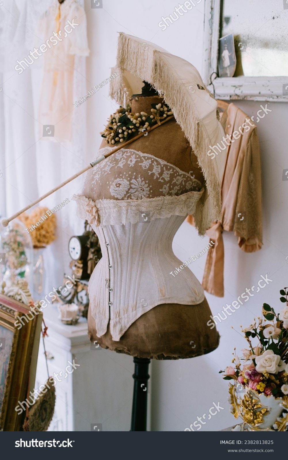 Antique Victorian corset and umbrella in a French antique store, with nice creamy colors and an old Victorian tone #2382813825