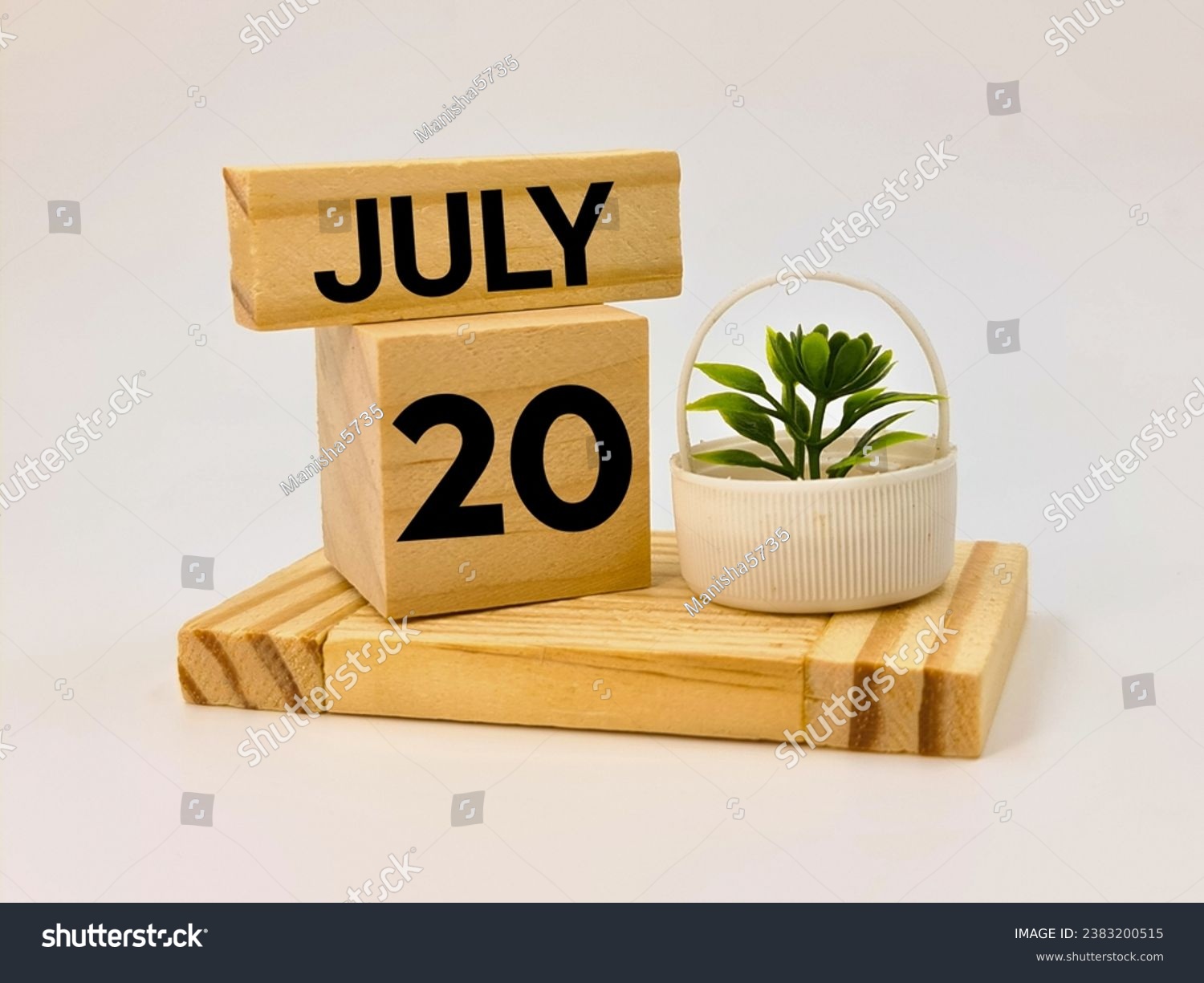 Twentieth July written over wooden blocks  #2383200515