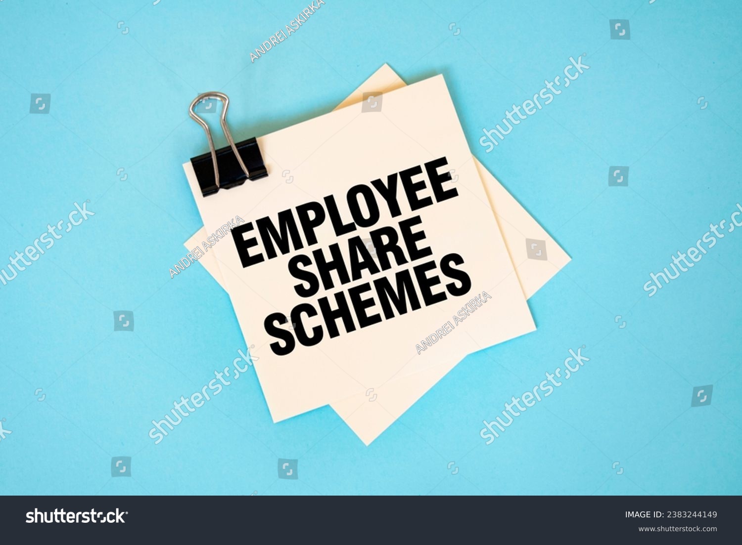Text EMPLOYEE SHARE SCHEMES on sticky notes with copy space and paper clip isolated on red background. Finance and economics concept. #2383244149