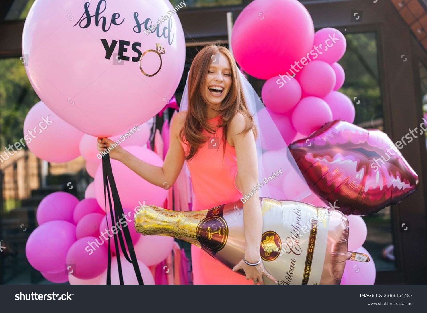 Portrait of happy charming redhead bride in summer wedding dress posing holding various colorful festive foil helium balloons standing by country house, closed eyes with happy expression. #2383464487
