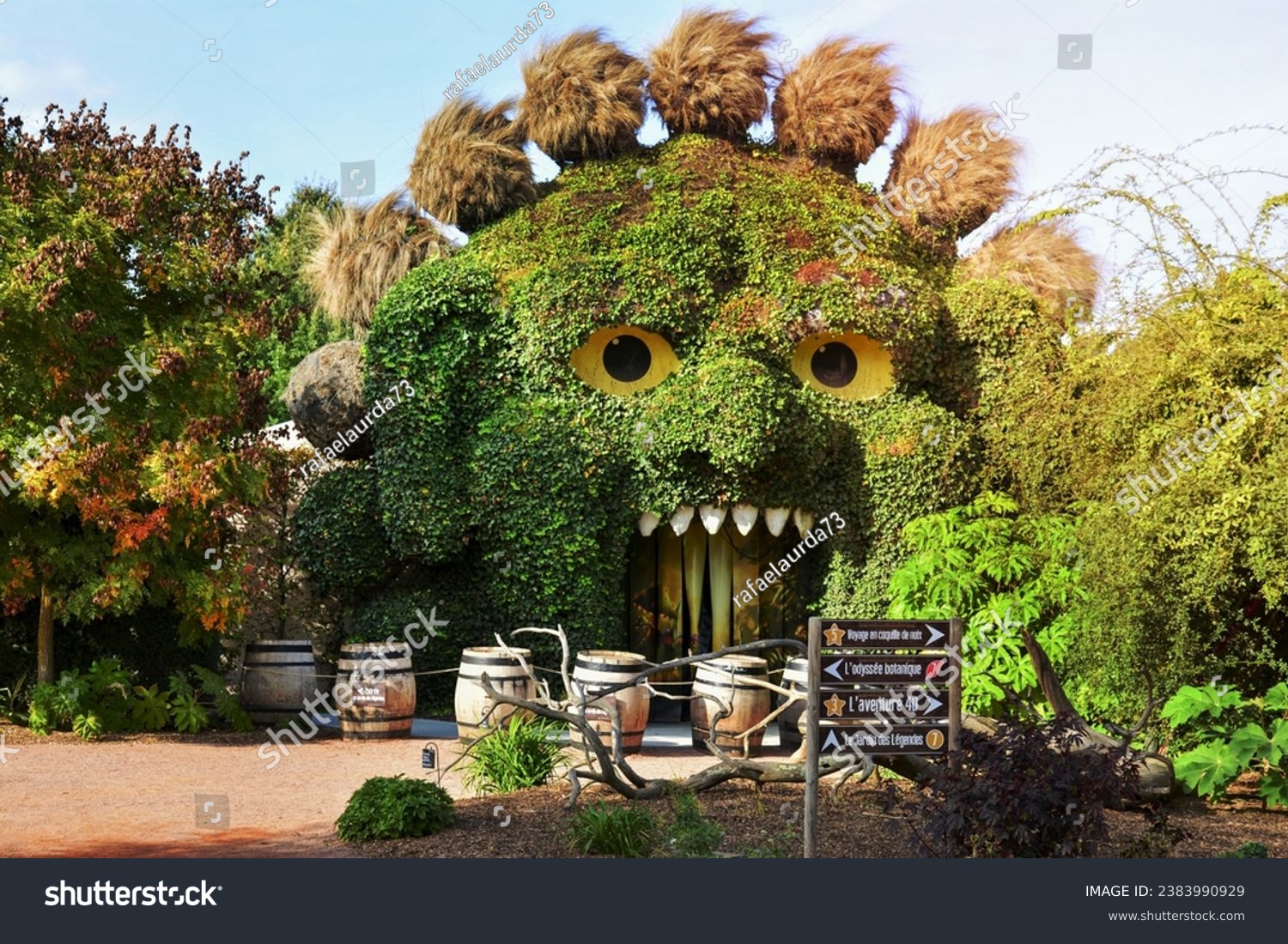 TERRA BOTANICA, ANGERS, FRANCE - SEPTEMBER 24, 2023: Head of a monster covered with ivy in a park landscape design. Grass figure #2383990929