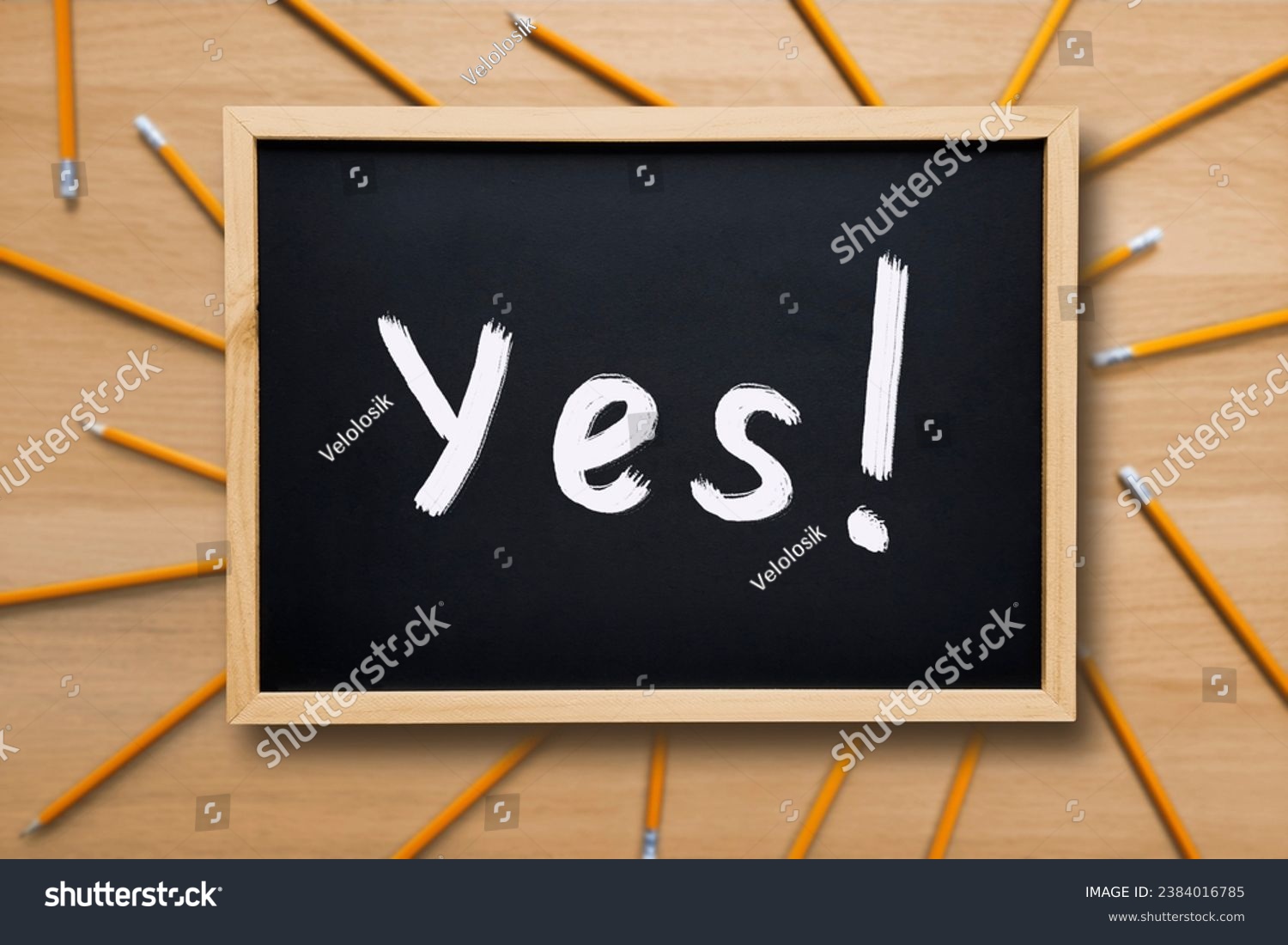 Yes Word on a school board. Yes concept. Text written with white chalk on a blackboard on background with pencils. Choice, definition, school, business, study. #2384016785
