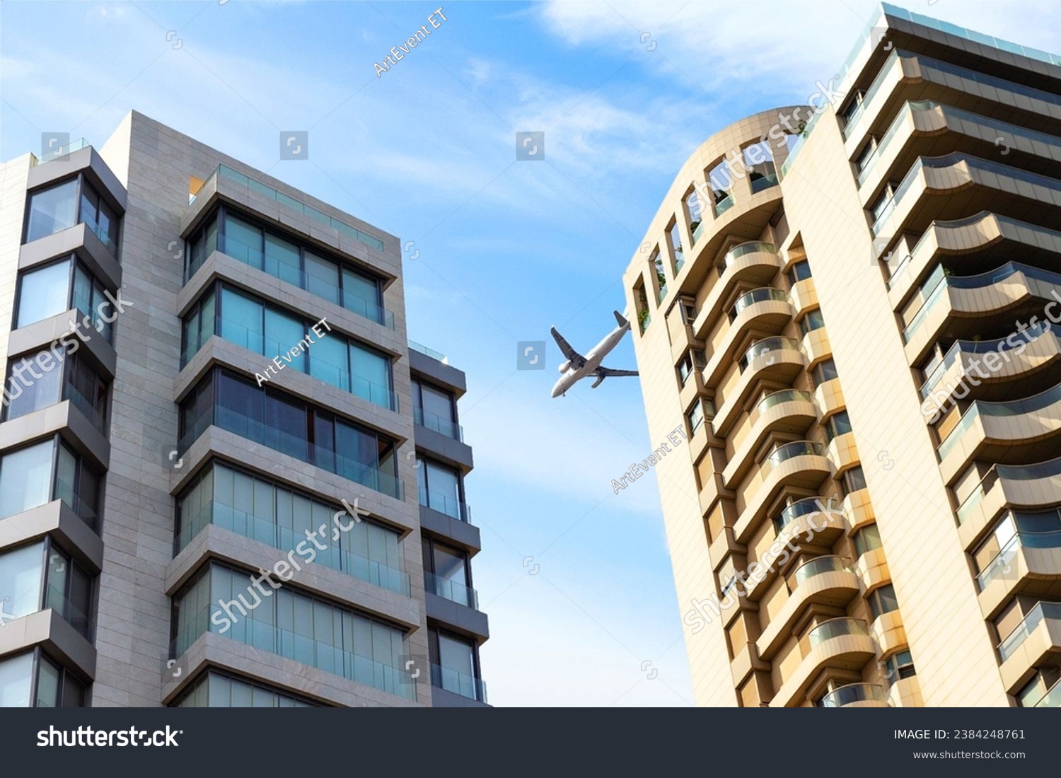 Big passenger plane over house. airplane is flying over building. bottom view #2384248761