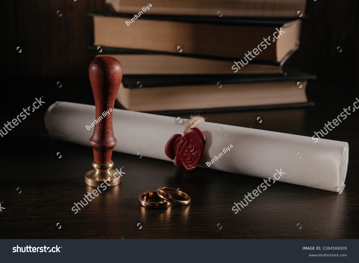 Marriage contract with seal and golden rings in a courtroom close-up. Family and law concept. #2384568009