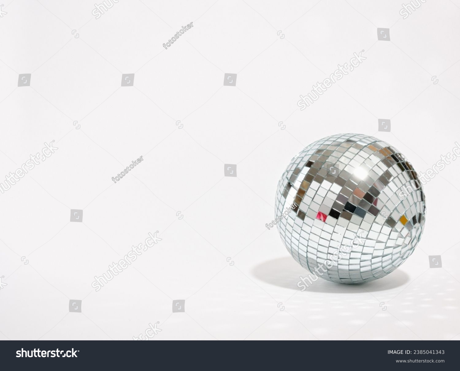 Mirror shining disco ball isolated. Copy space for text. Concept of party and celebration. #2385041343