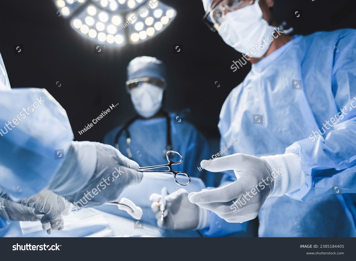 Close up of surgery team operating in modern hospital. Medical workers teamwork, saving rescuing patient`s life during plastic cardio surgery. Organs transplantation #2385184405