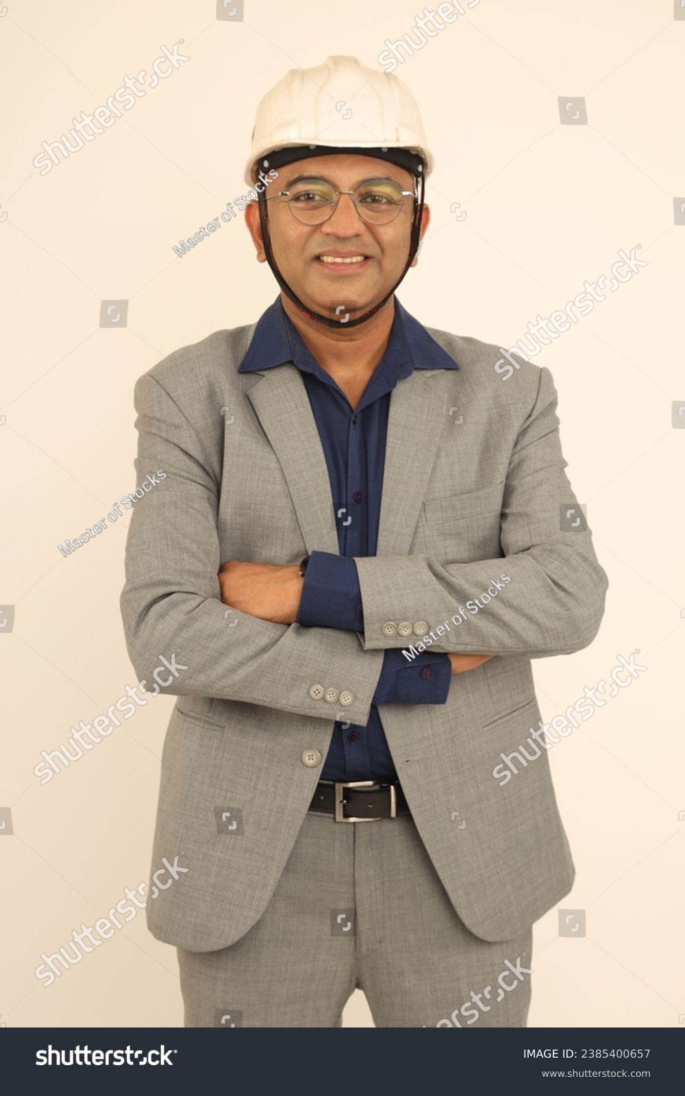 Portrait of Confident smart male  engineer in white hardhat over formal suit and looking at camera while isolated on studio background #2385400657