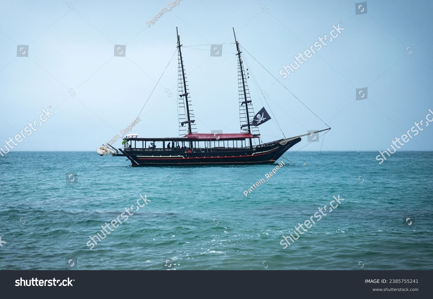 Pirate ship on the high seas, horizontal landscape photo, Tour boat, Piracy on the beach. Brazilian Sea, Ilha Bela. Calm sea. #2385755241
