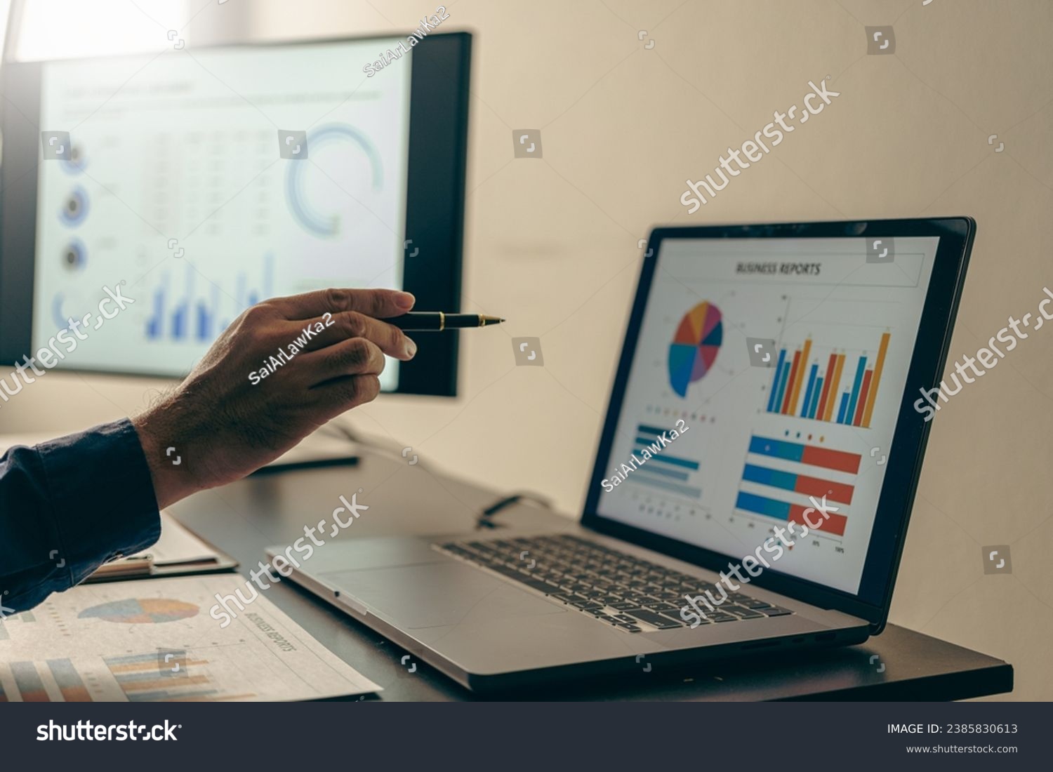 Young Asian businessman working with laptop, checking graphs, company budget reports, production control. Operational inspection cost plus price Close-up pictures #2385830613